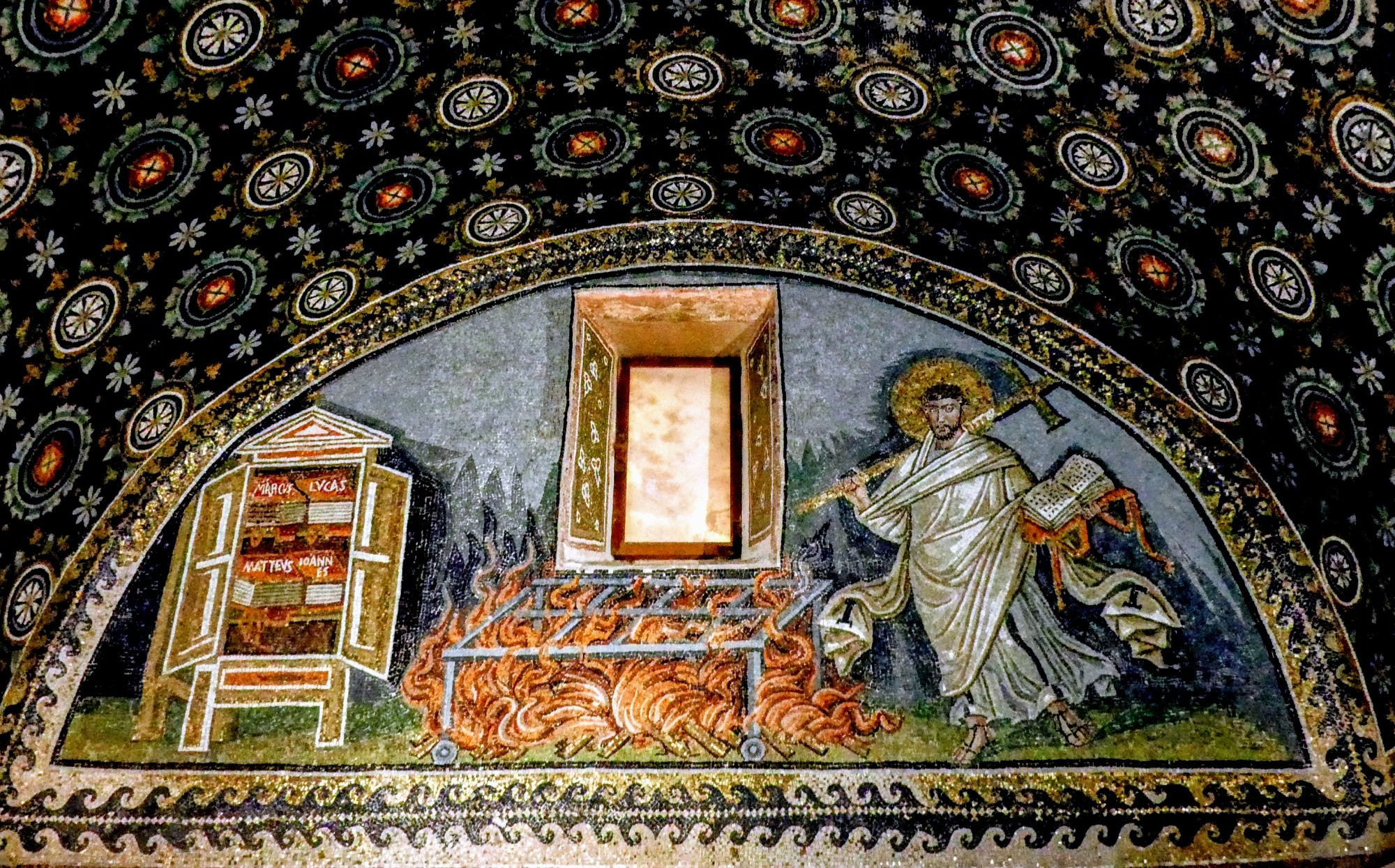 Mosaic in the Mausoleum of Galla Placidia, Ravenna. A lunette depicts Christ holding a cross and book, standing next to a burning grill. On the left is a cabinet labeled 'MARCUS LUCAS' containing scrolls. The scene is framed by an ornate arch with a starry night sky pattern above, featuring golden stars and floral motifs on a dark blue background.