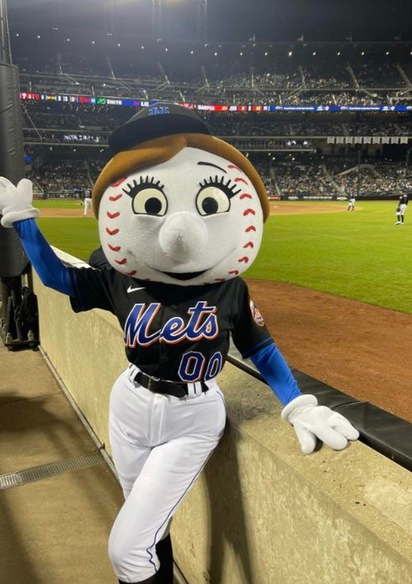 Mrs. Met in a black Mets jersey and white pants...uhhhh...looks like she's posing in the seats down the right field line at Shea Stadium (I don't know what the new name is)