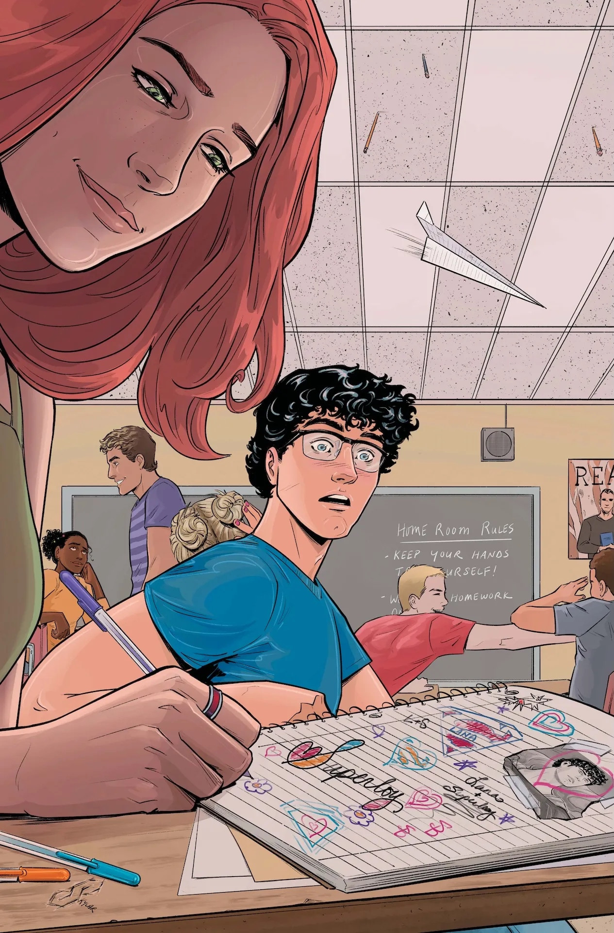 Cover for Action comics 1092, low angle shot looking past Lana Lang who writes in her notebook in the foreground. Notebooks filled with doodles & clippings of Superboy with hearts & stars. Beyond her, a chaotic classroom of students & at its center, Clark stars in shock at Lana’s notebook