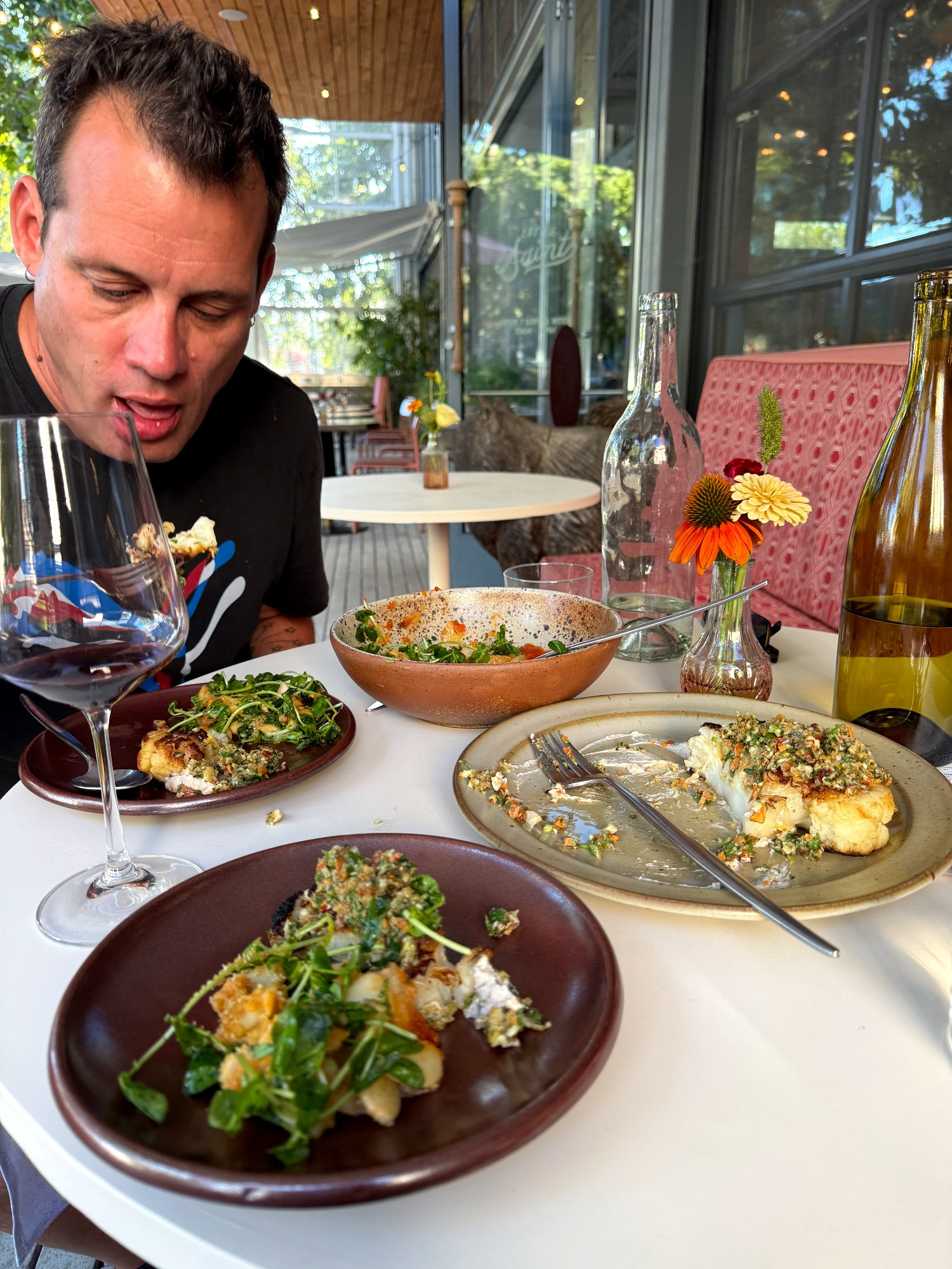 The author, looking like an idiot, about to put some roasted cauliflower in his mouth. There's also a plate of beans with micro greens 