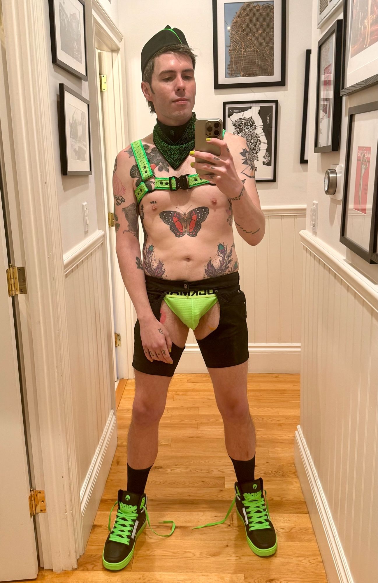 Me in a black and neon green outfit consisting of flight cap, harness, chaps, jock, sneakers and neckerchief