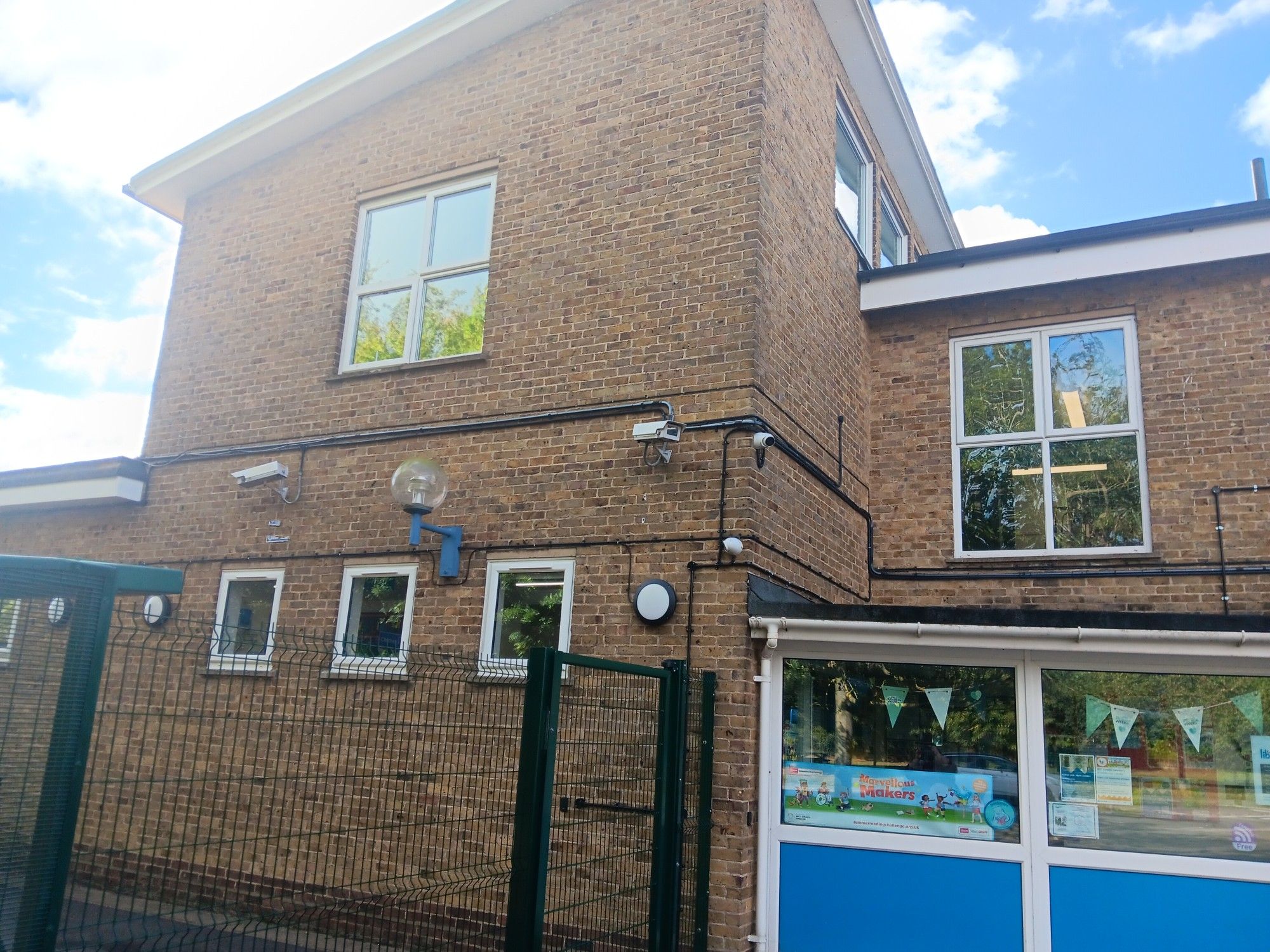 An exterior view of Comberton Library, a 1960s brick building on the site of Comberton Village College.