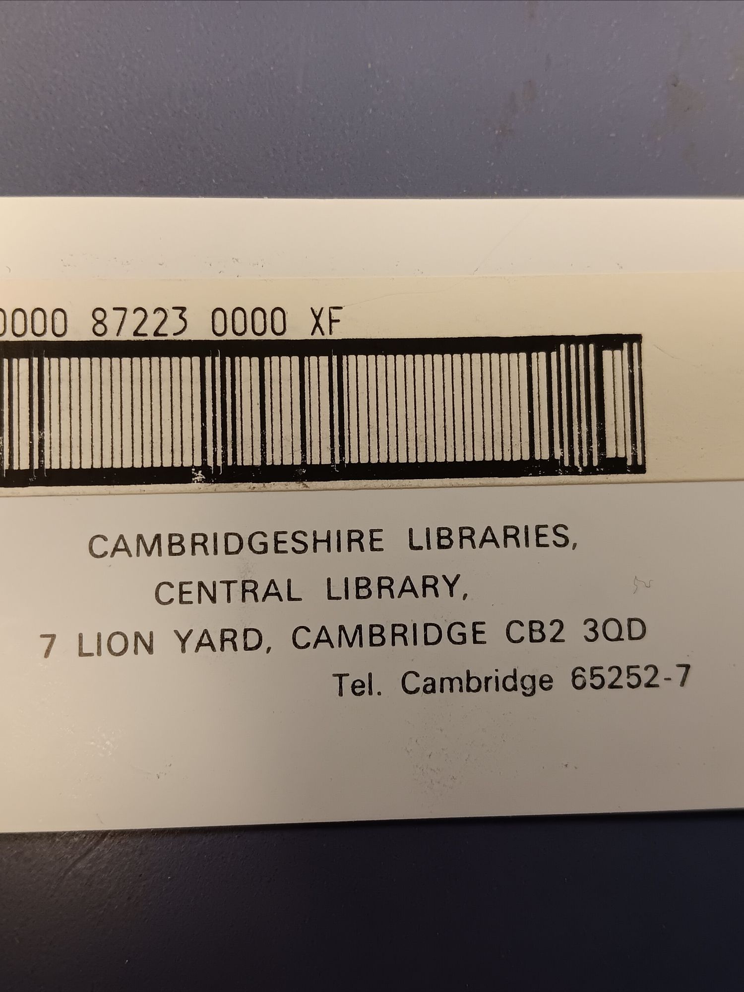 A library card made of white card, with a barcode along the top and the address of Cambridge Central library below