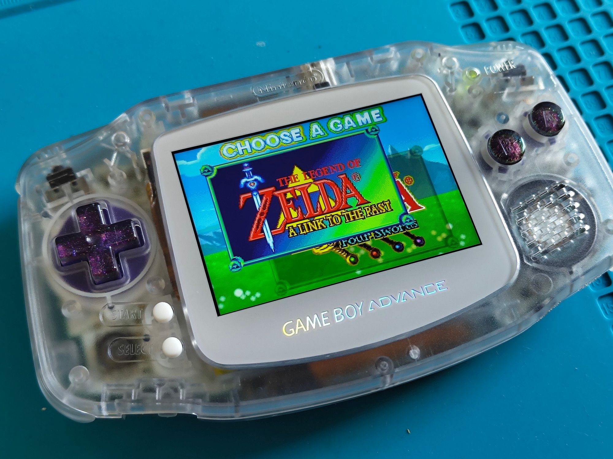 Gameboy Advance with IPS screen, transparent shell, sparkly purple buttons, and white screen cover