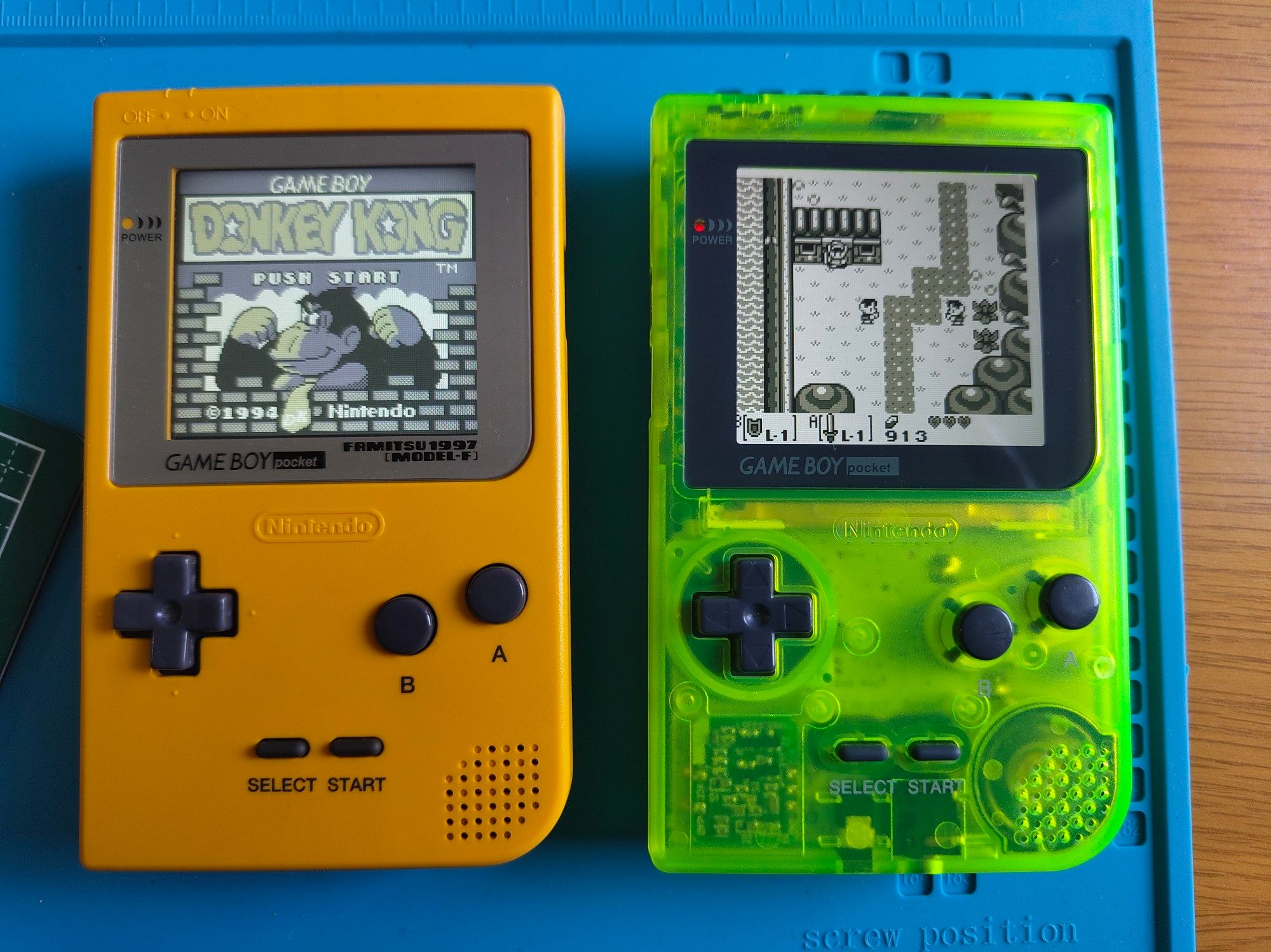 Two gameboy pockets, one yellow, one transparent green, both with IPS screen mods