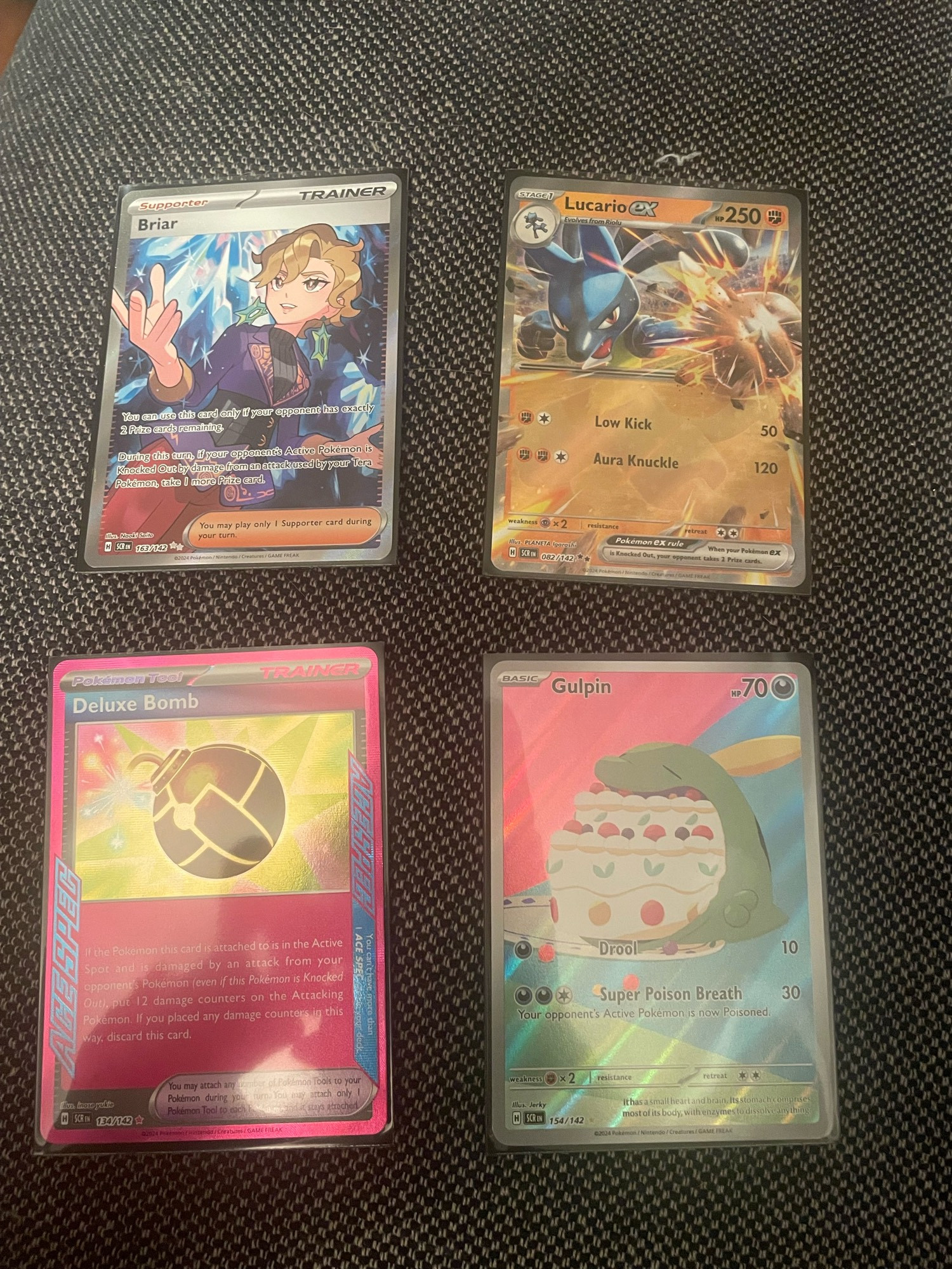 Grid Pokémon cards.

Briar Full Art, Lucario EX
Deluxe Bomb ACESPEC and Gulpin Art Rare