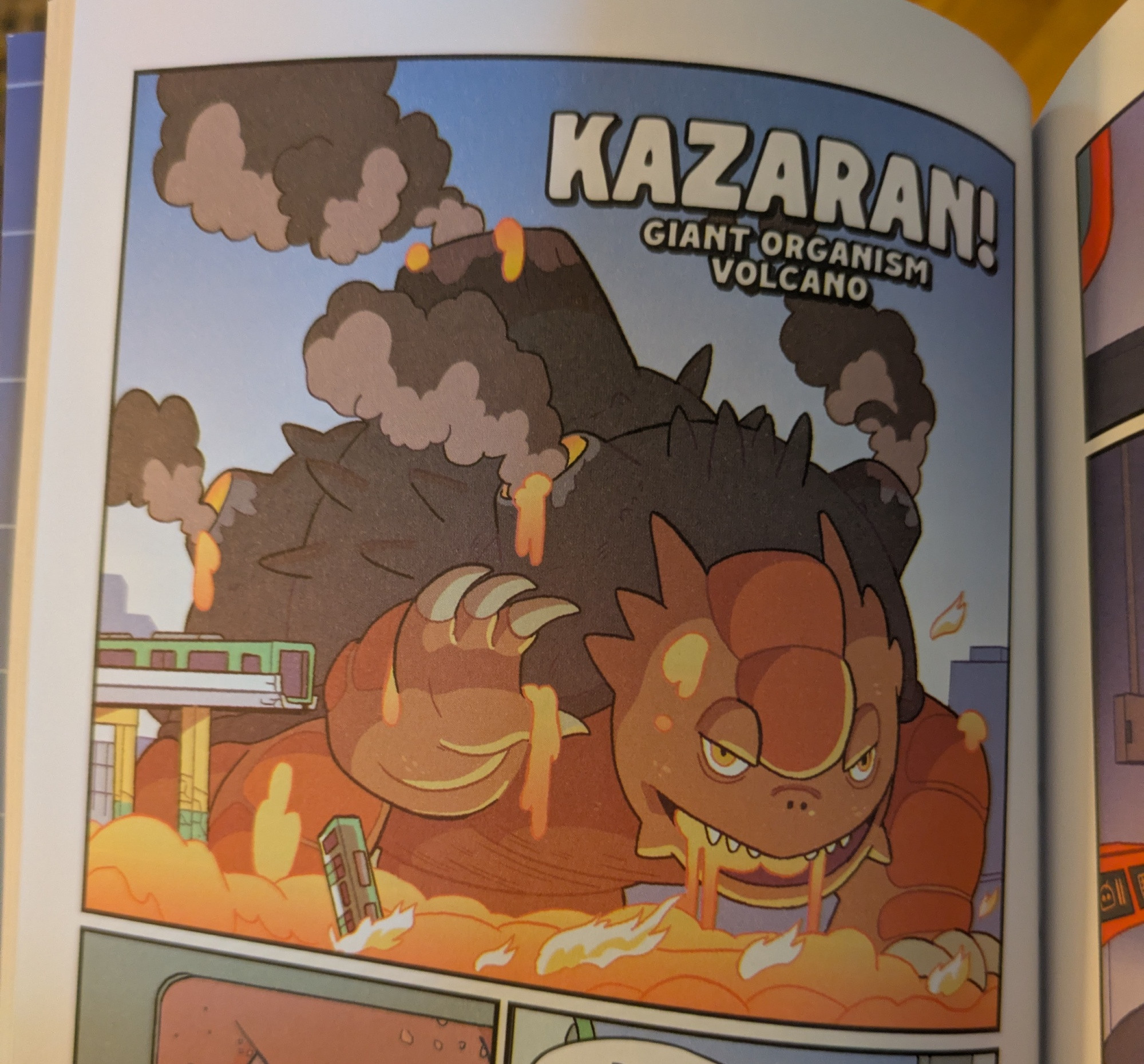 A cute drawing of a turtle-like kaiju with a volcano on his back. Large text reads KAZARAN! GIANT ORGANISM VOLCANO