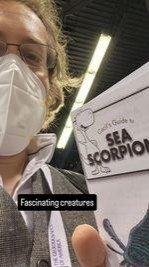 Me presenting the leaflet, which is called "cecil's guide to sea scorpions". The caption reads "fascinating creatures"