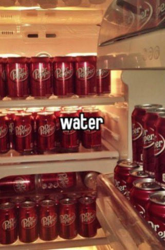 A fridge completely filled to the brim with cans of Dr. Pepper