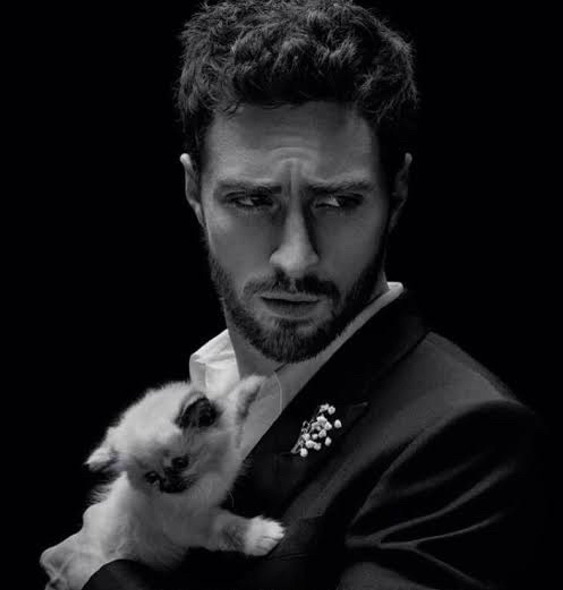 Aaron Taylor-Johnson with white kitten black and white photo.