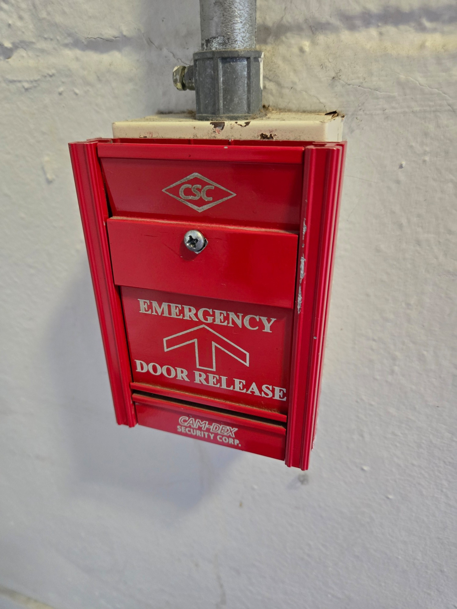 An emergency door release handle that had been screwed down so it cannot be activated.