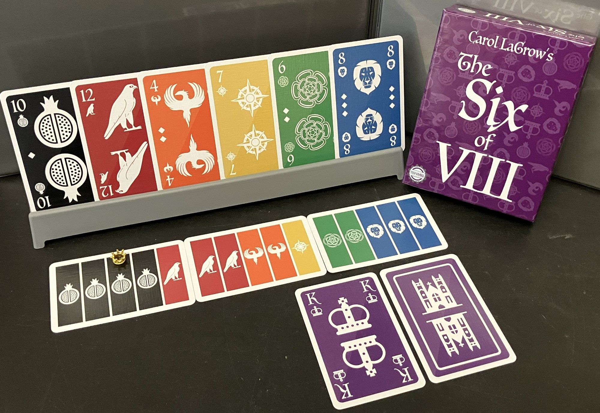 A display of the cards and box front for The Six of VIII by Carol LaGrow, published by New Mill Industries