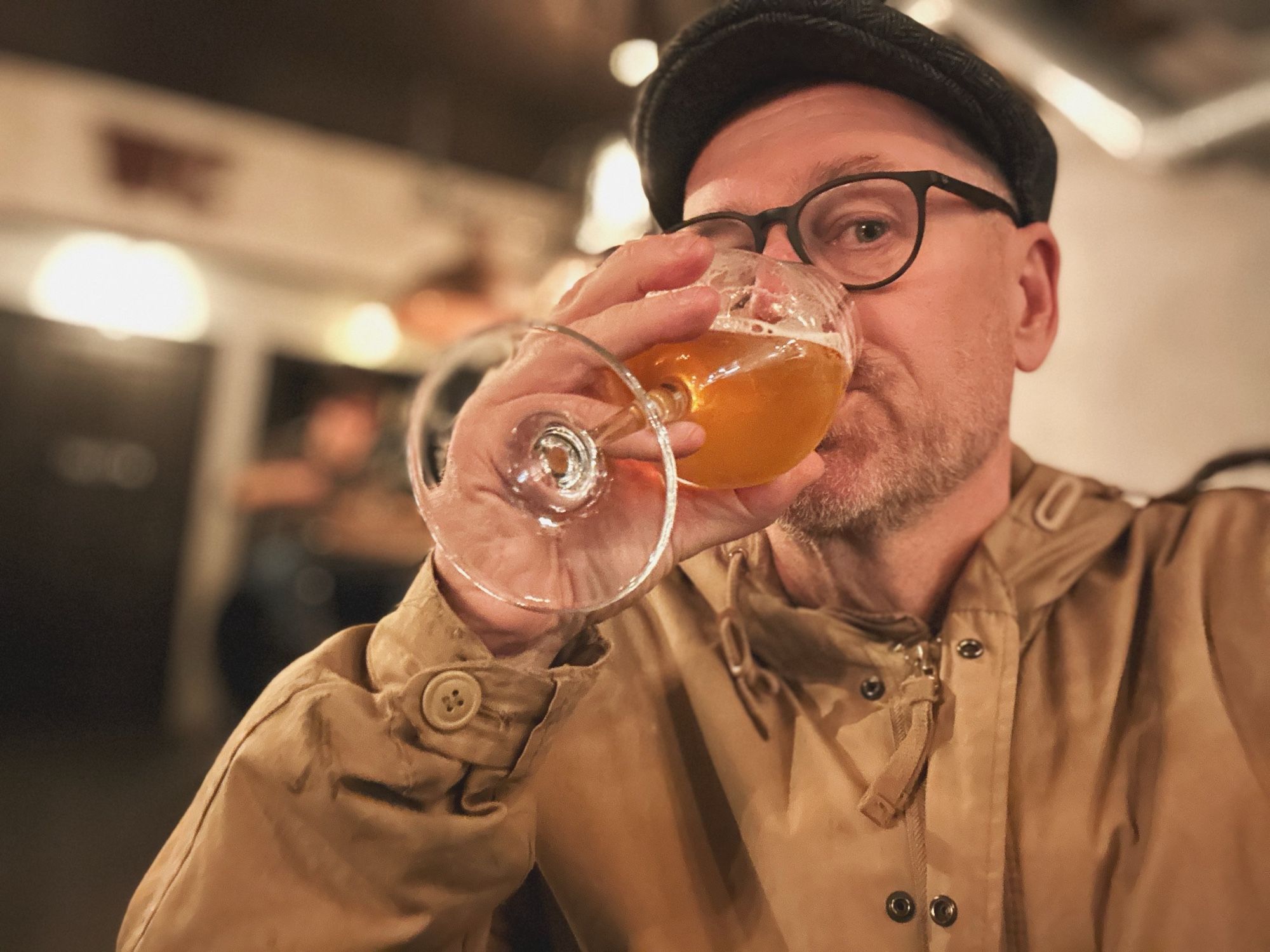 Tired 50 something man drinking beer while waiting for his take away food.