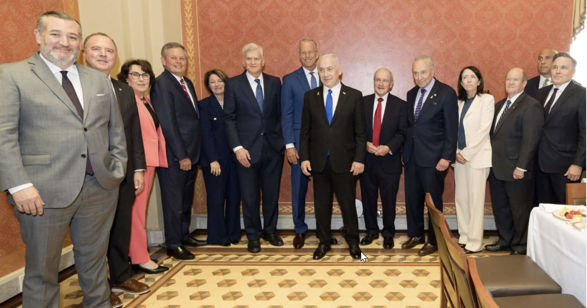 Photo of Adam Schiff, Ted Cruz, Chuck Schumer, Cory Booker & others smiling gathered around Netanyahu at a luncheon in the US.