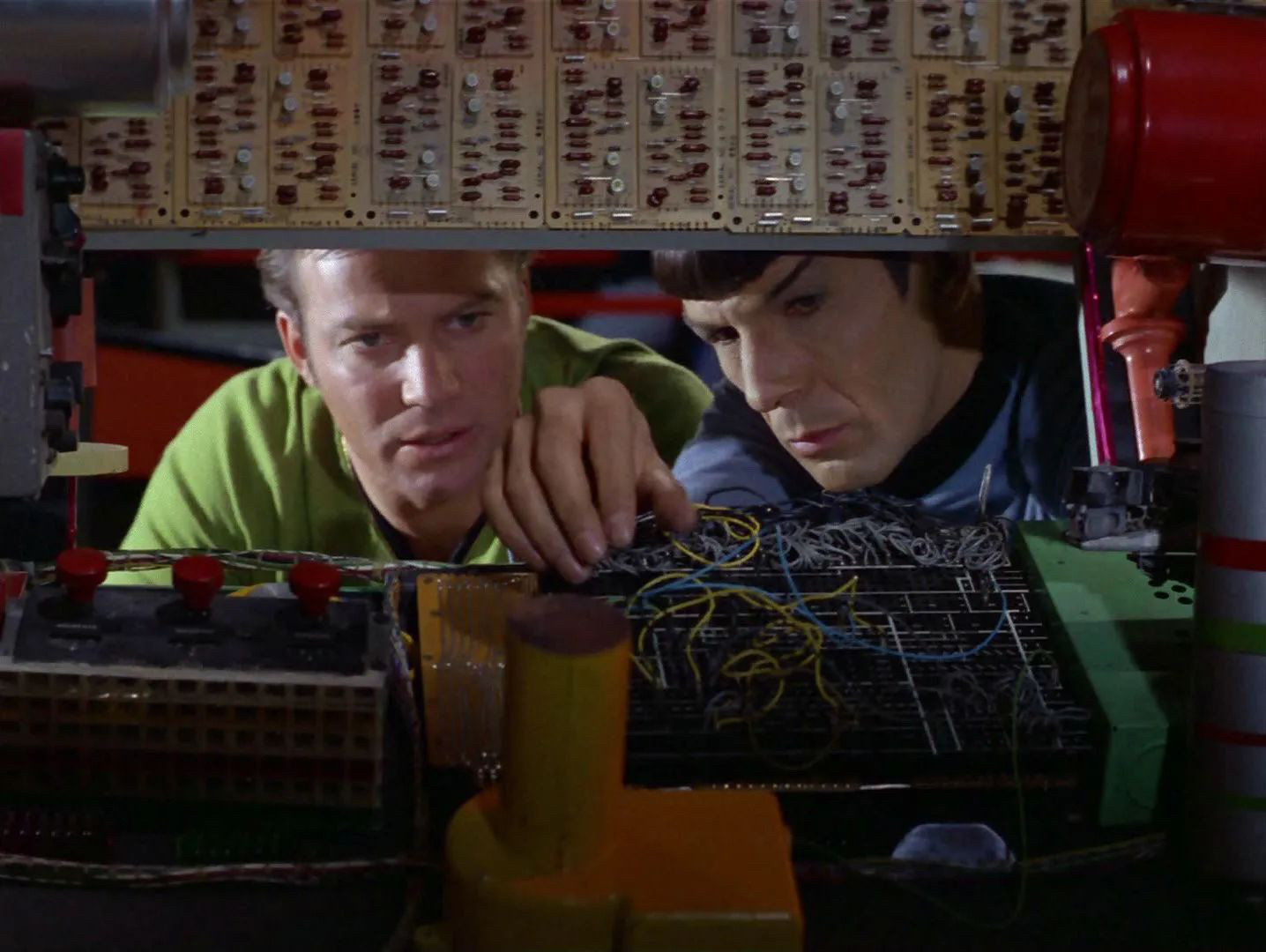 Spock is fiddling with boxes and wires that look like a modular synth. Jim looks on, suddenly realizing where most of Spock's pay goes...