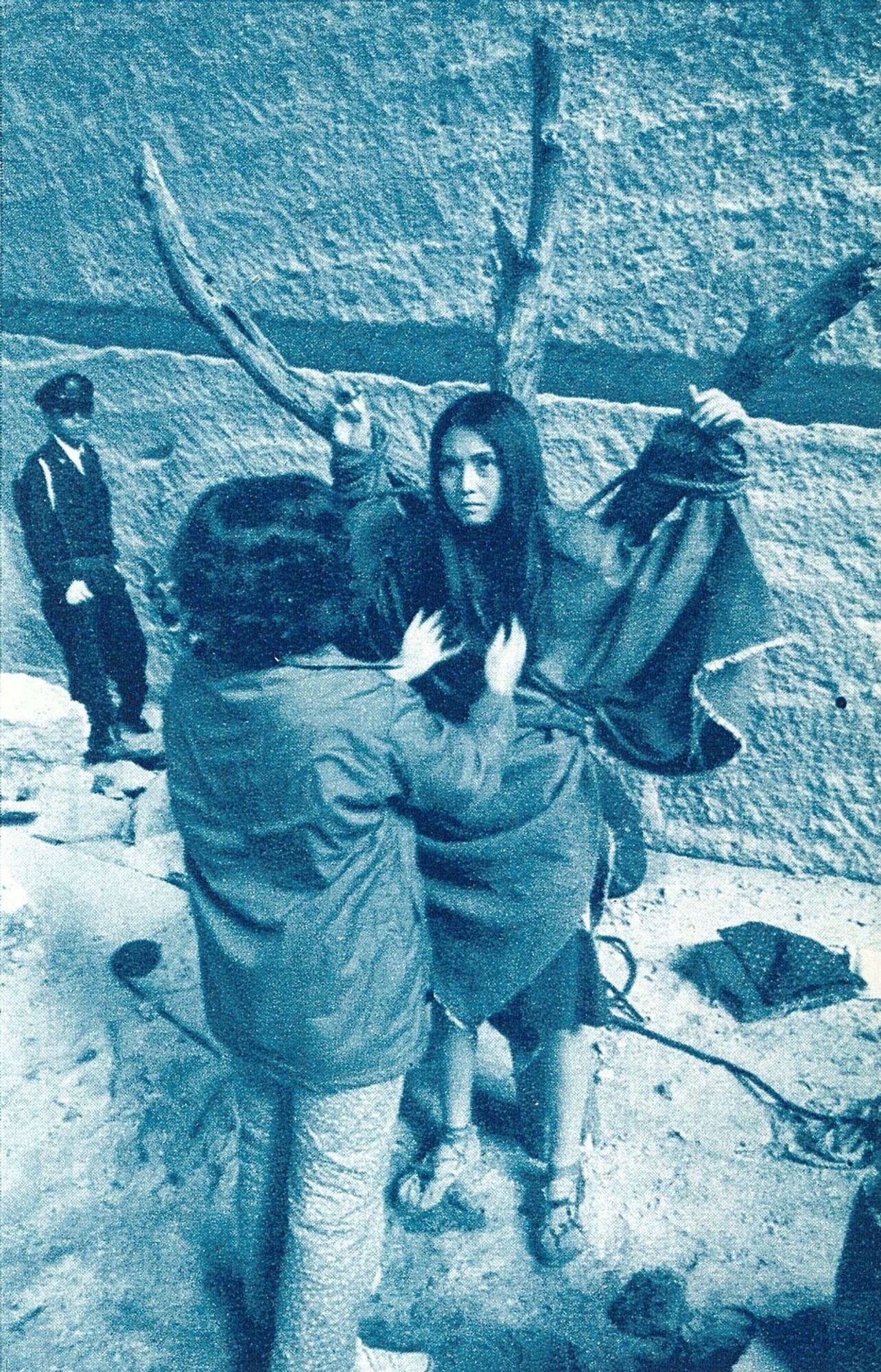 Meiko Kaji (梶芽衣子) on the set of Female Convict Scorpion: Jailhouse 41 (女囚さそり 第４１雑居房) 1972. The picture is blue and white and shows someone in the crew attending to Meiko while she is tied to the tree.

Scanned from Kinema Junpo (キネマ旬報),  January 1973.