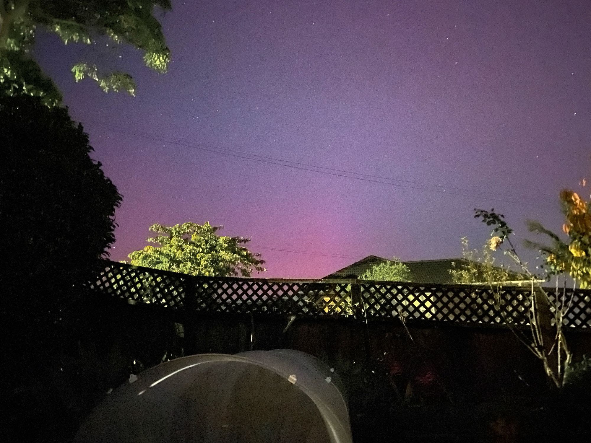 Sky over the garden fence, pink glow on the horizon