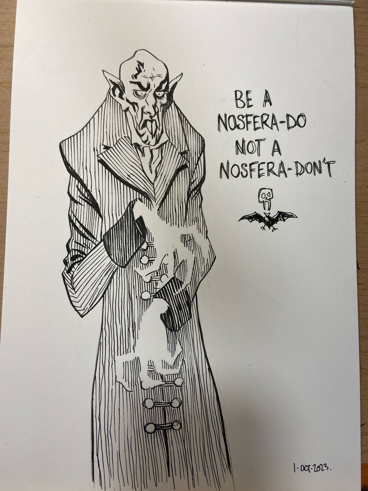 Count or lack, the nosferatu. A decent black and white pen and ink drawing by me. He’s skinny and a bit goofy looking. Beside him is a slogan I’ve written “be a nosfera-DO not a nosfera-DON’T”