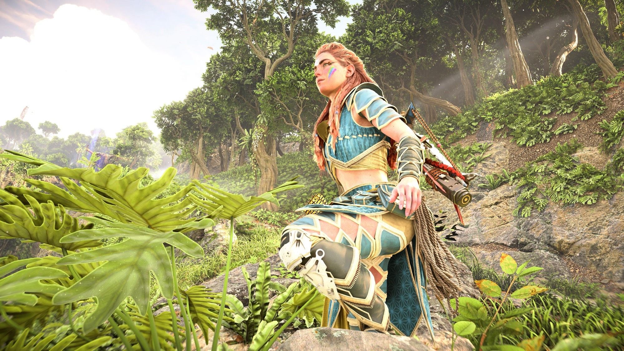 Another screenshot of Aloy, as she stands with one foot up on a rock and stares off into the distance.