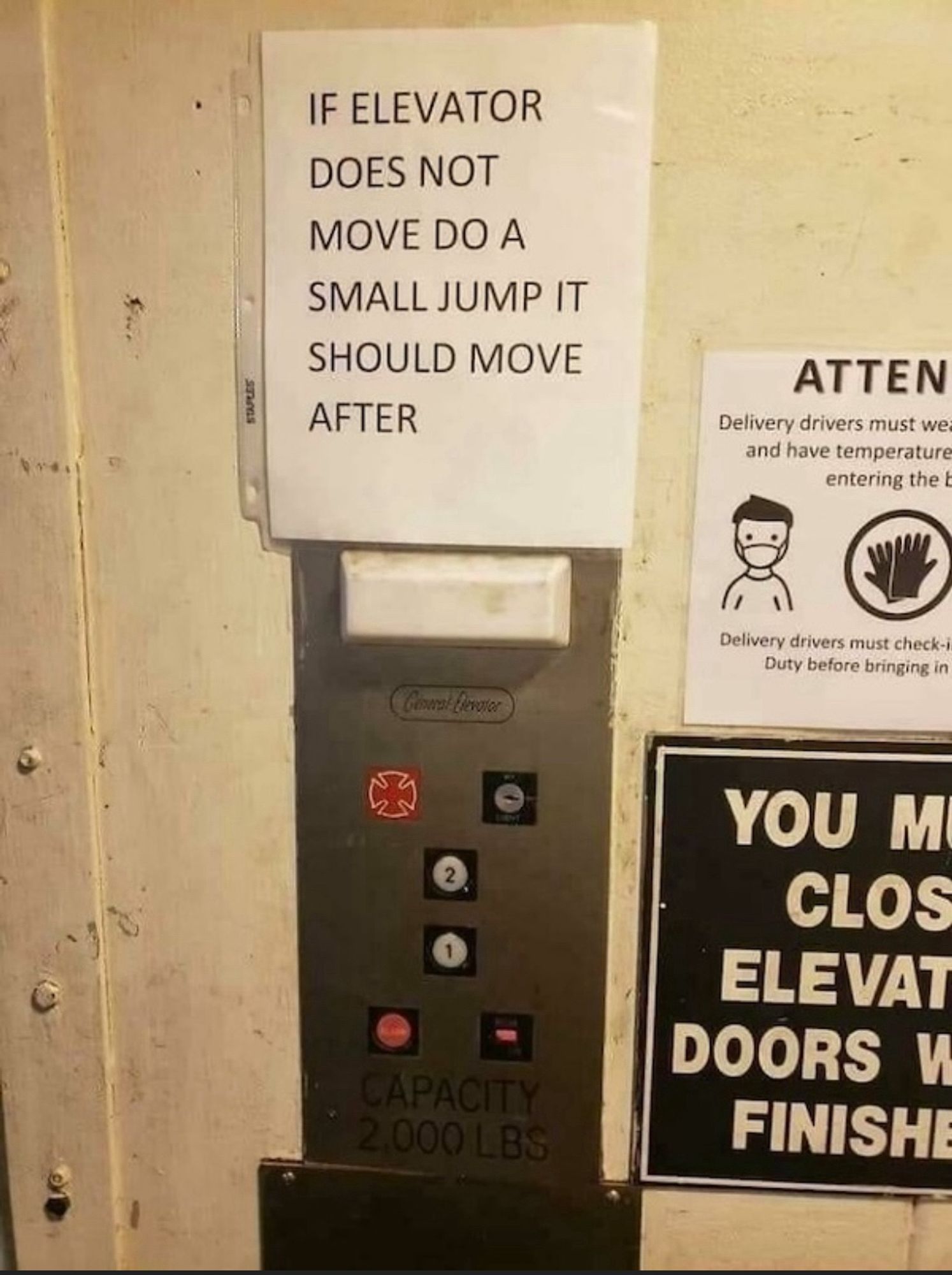 Sign on an elevator saying if it doesn’t move to jump a little bit