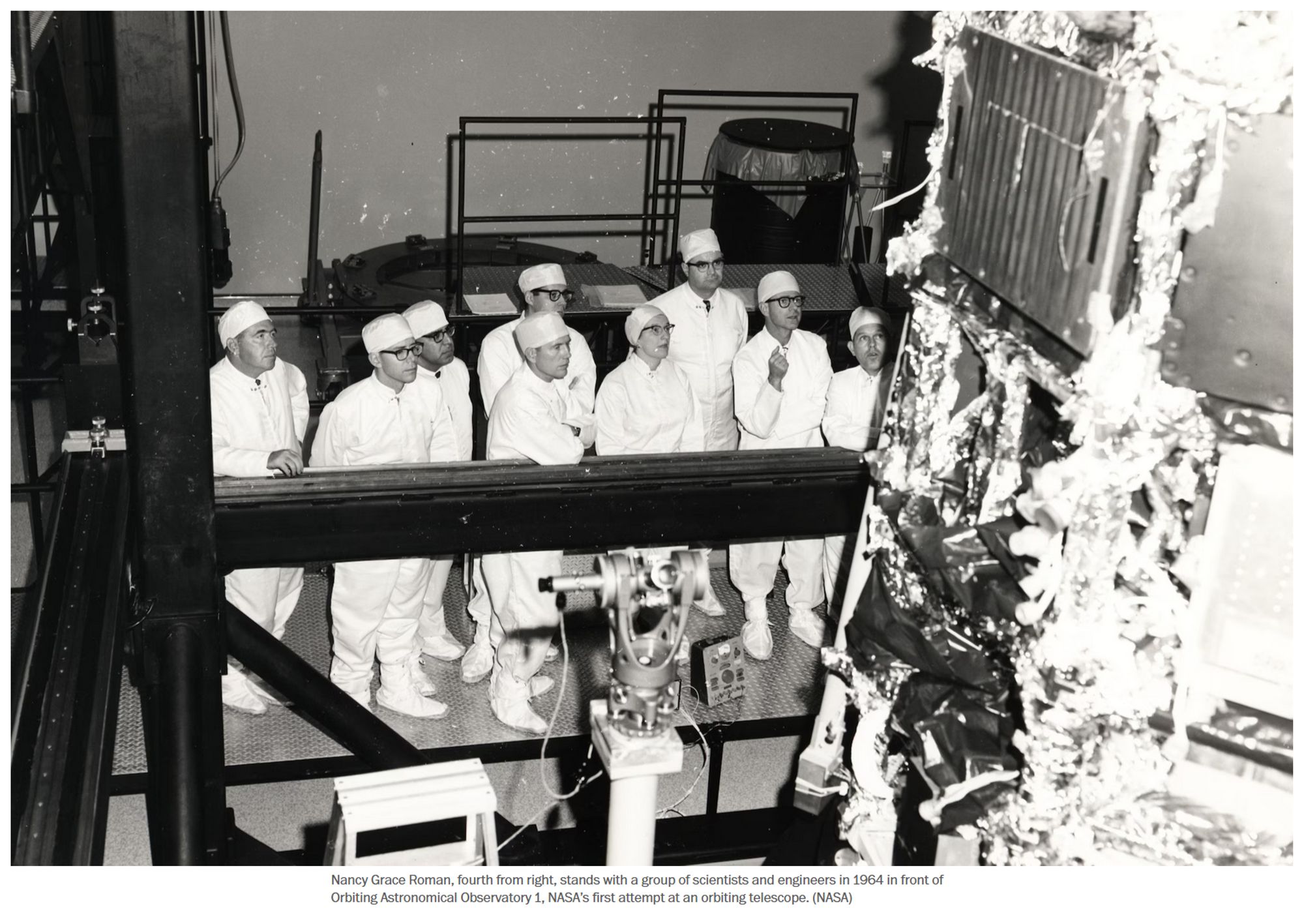 Photo with caption:
Nancy Grace Roman, fourth from right, stands with a group of scientists and engineers in 1964 in front of Orbiting Astronomical Observatory 1, NASA’s first attempt at an orbiting telescope. (NASA) 