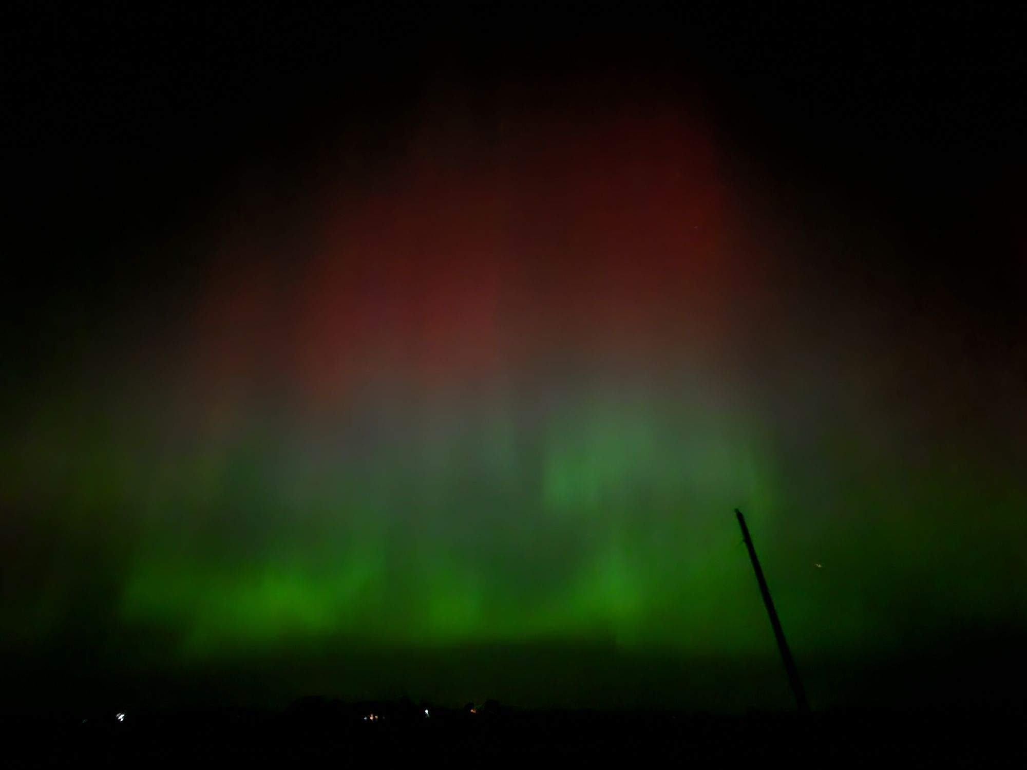 Wide-angle shot, northern lights, red over sinuous green