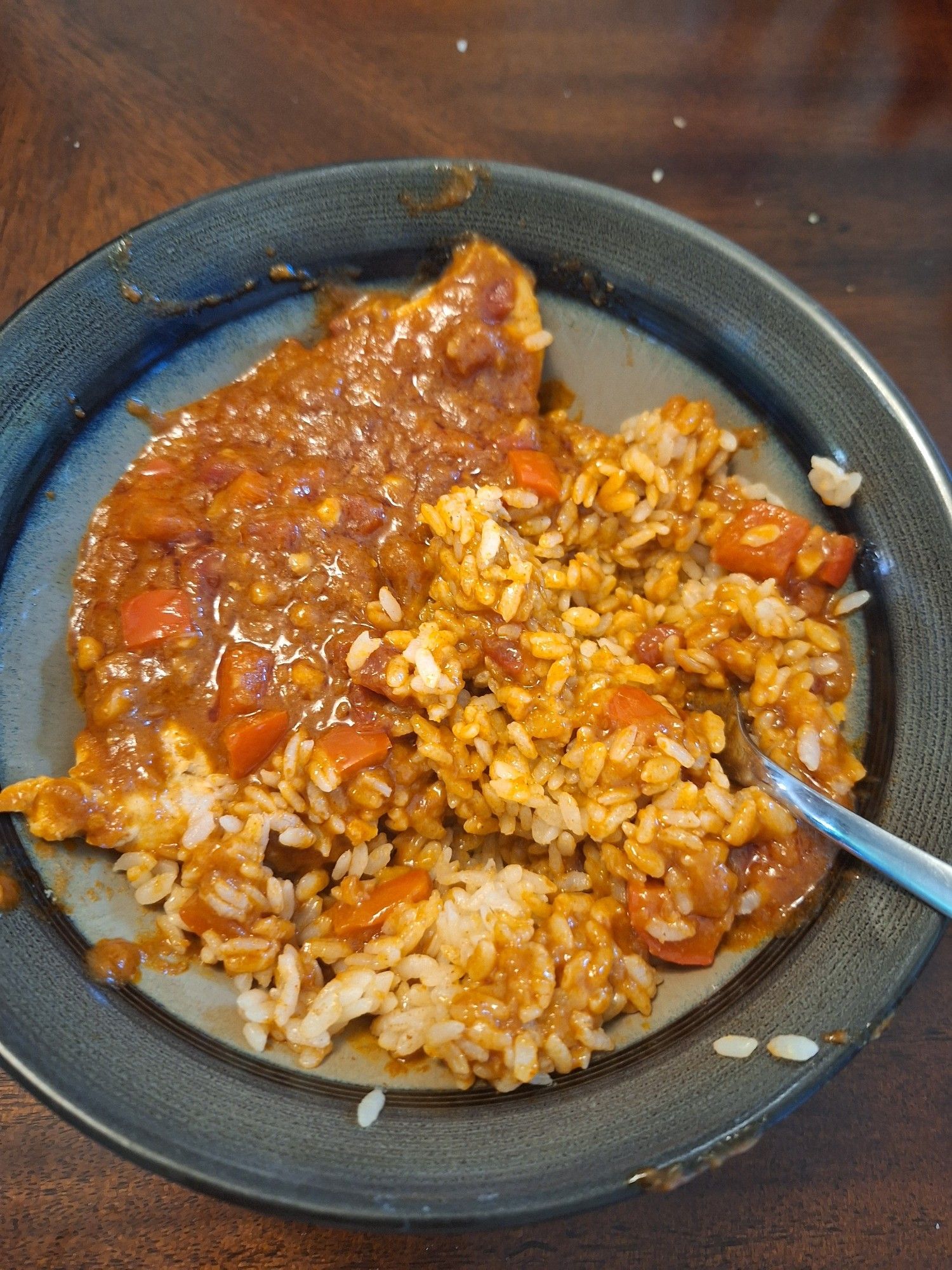 A chicken paprikash (with lots of the paprikash sauce) with rice in a bowl