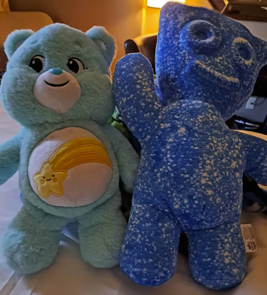 plush of wish bear from care bears and a big plush of a blue sour patch kids