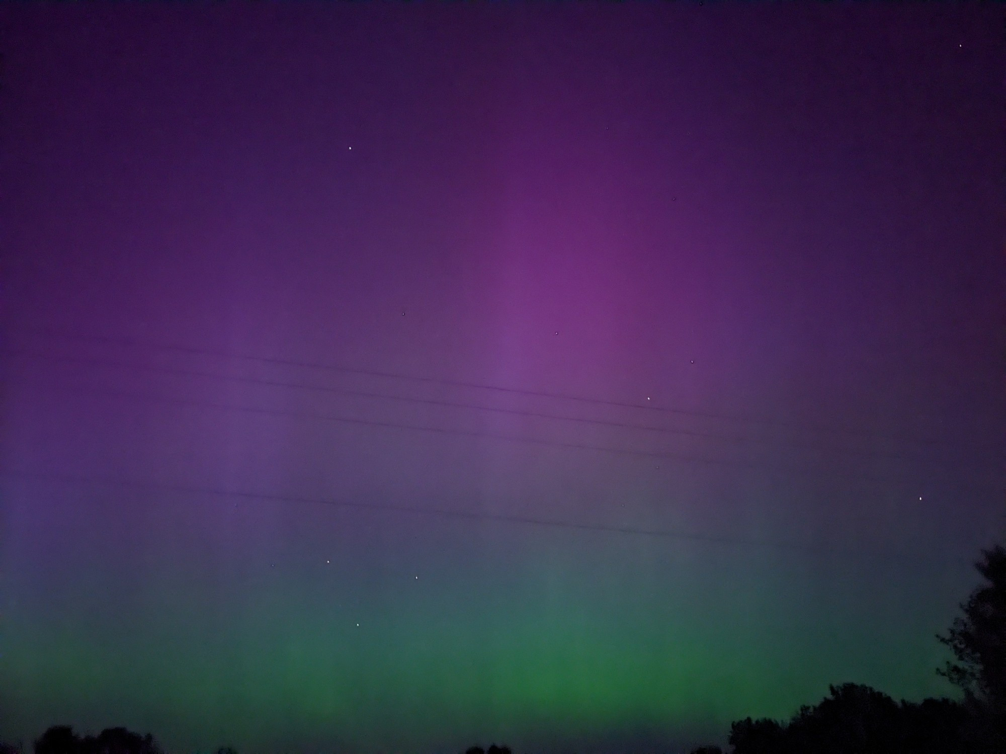 The night sky with streaks of purple and green.