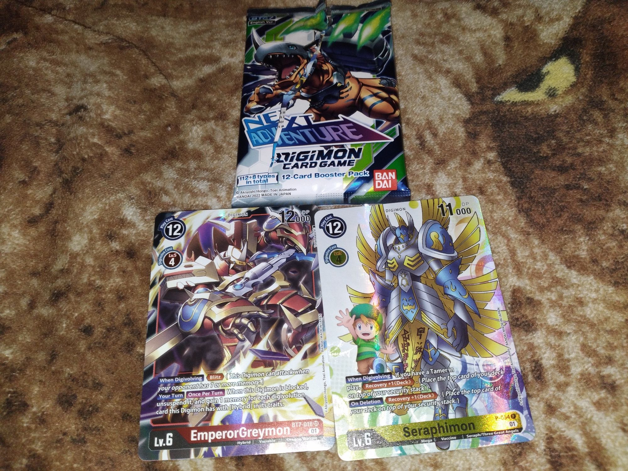 The highlight of pulls a cool digimon character card named EmperorGreymon holo and a cool digimon textured card called Seraphimon