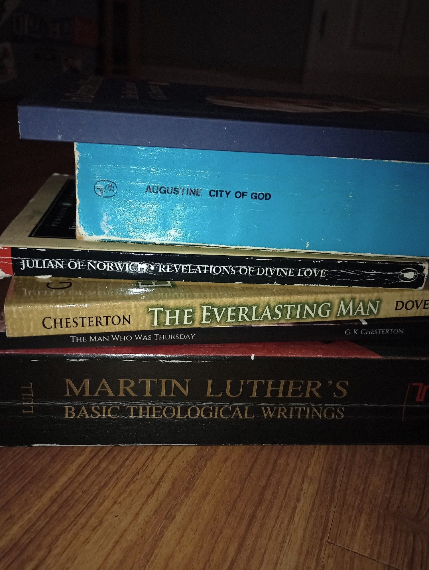 top to bottom: In Defense of Sanity, The Best Essays of GK Chesterton; The City of God by Augustine; Revelations of Divine Love by Julian of Norwich; The Everlasting Man by GK Chesterton; The Man Who Was Thursday by GK Chesterton; and Fortress Press' edition of Martin Luther's Basic Theological Writings