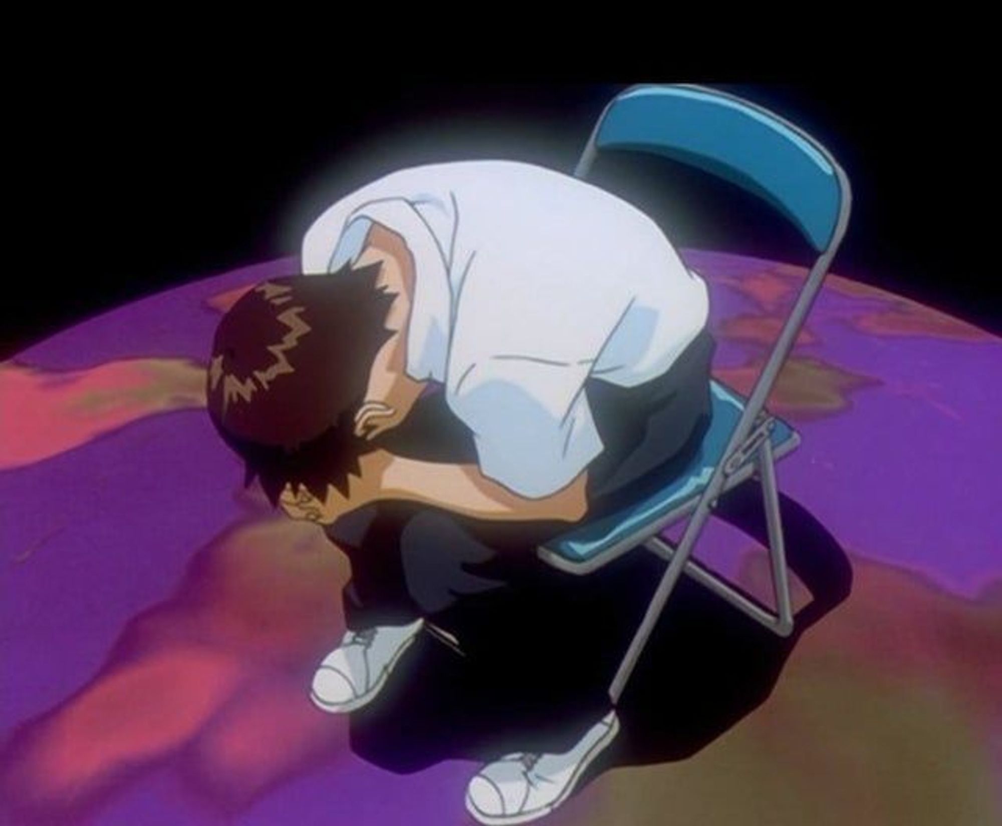 Shinji Ikari from Neon Genesis Evangelion leaning forward in a metal chair with his head against his hands, which are clasped together.