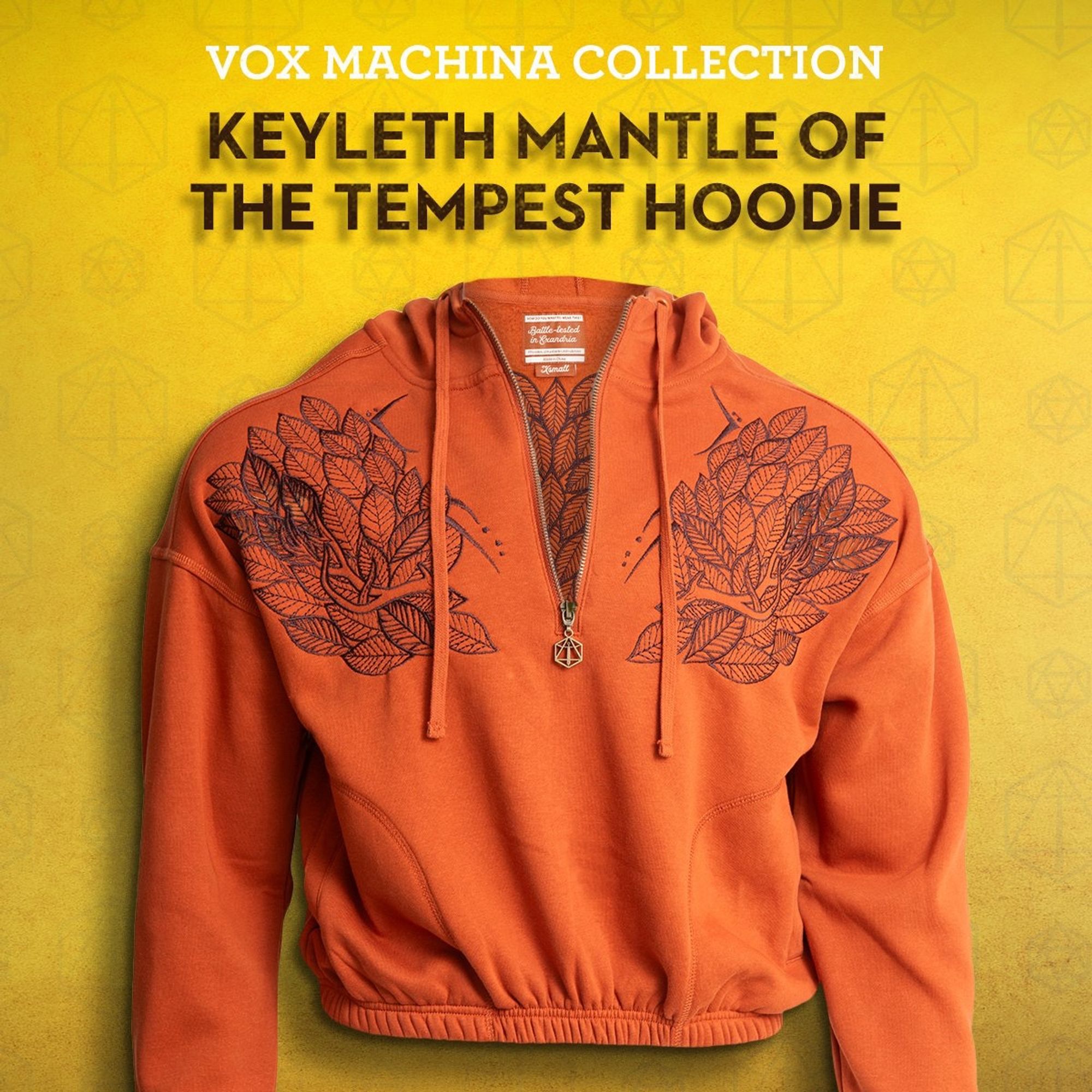 Vox Machina Collection 
Keyleth Mantle of Tempest Hoodie 

a little orange cropped Hoodie with a halfway zipper, the zipper is the critical role logo and the hoodie has keyleth‘s antlers + lots of leaves in black embroidered