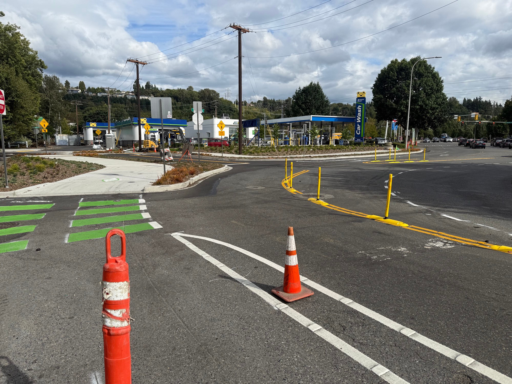 A road curves tightly to slow drivers next to a newly paved 2-way protected bike lane at 7th Street and Talbot Road 
