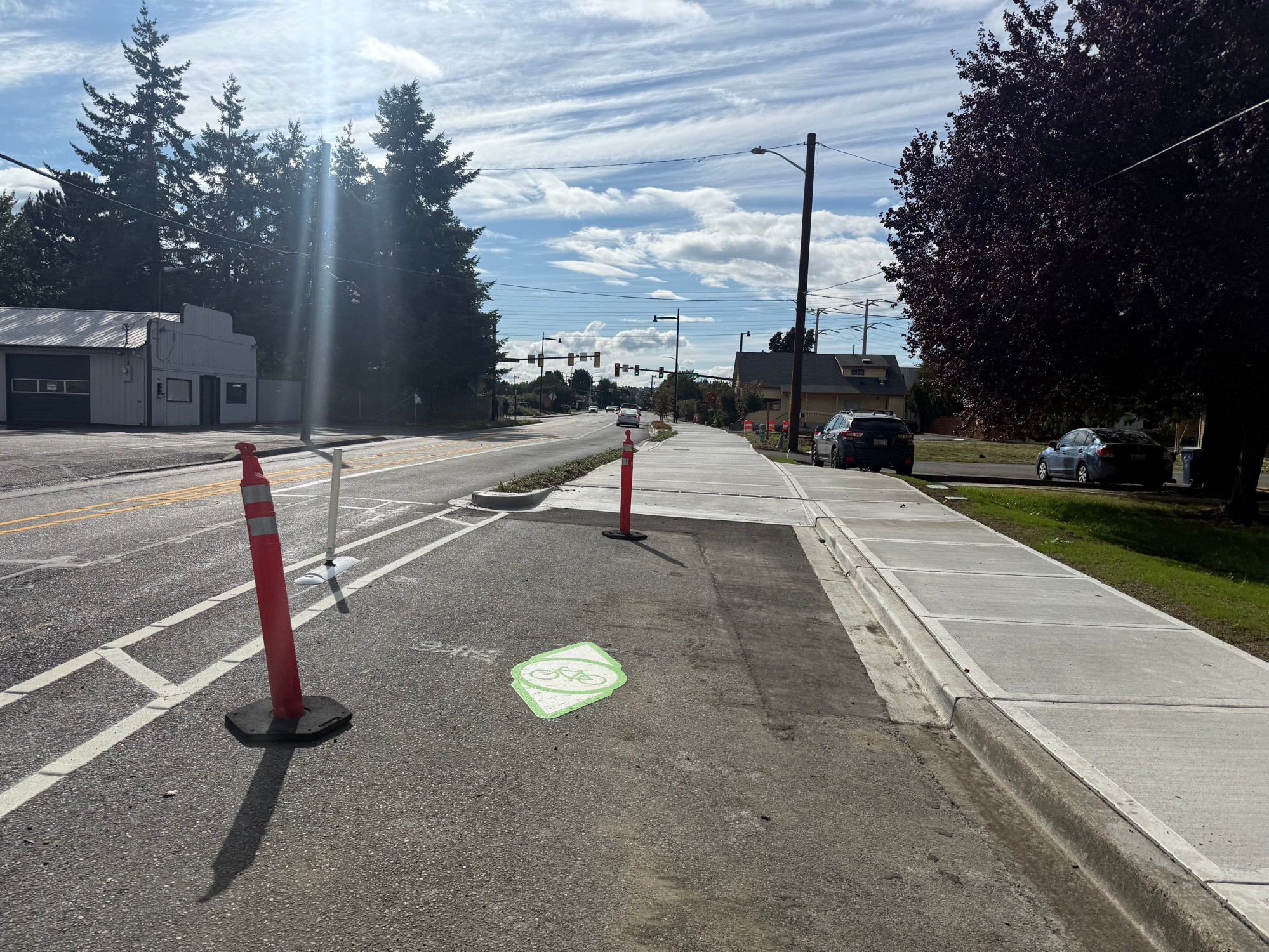 A new 2-way protected bike lane transitions from street level to a sidewalk level wide shared use path on 7th Street 