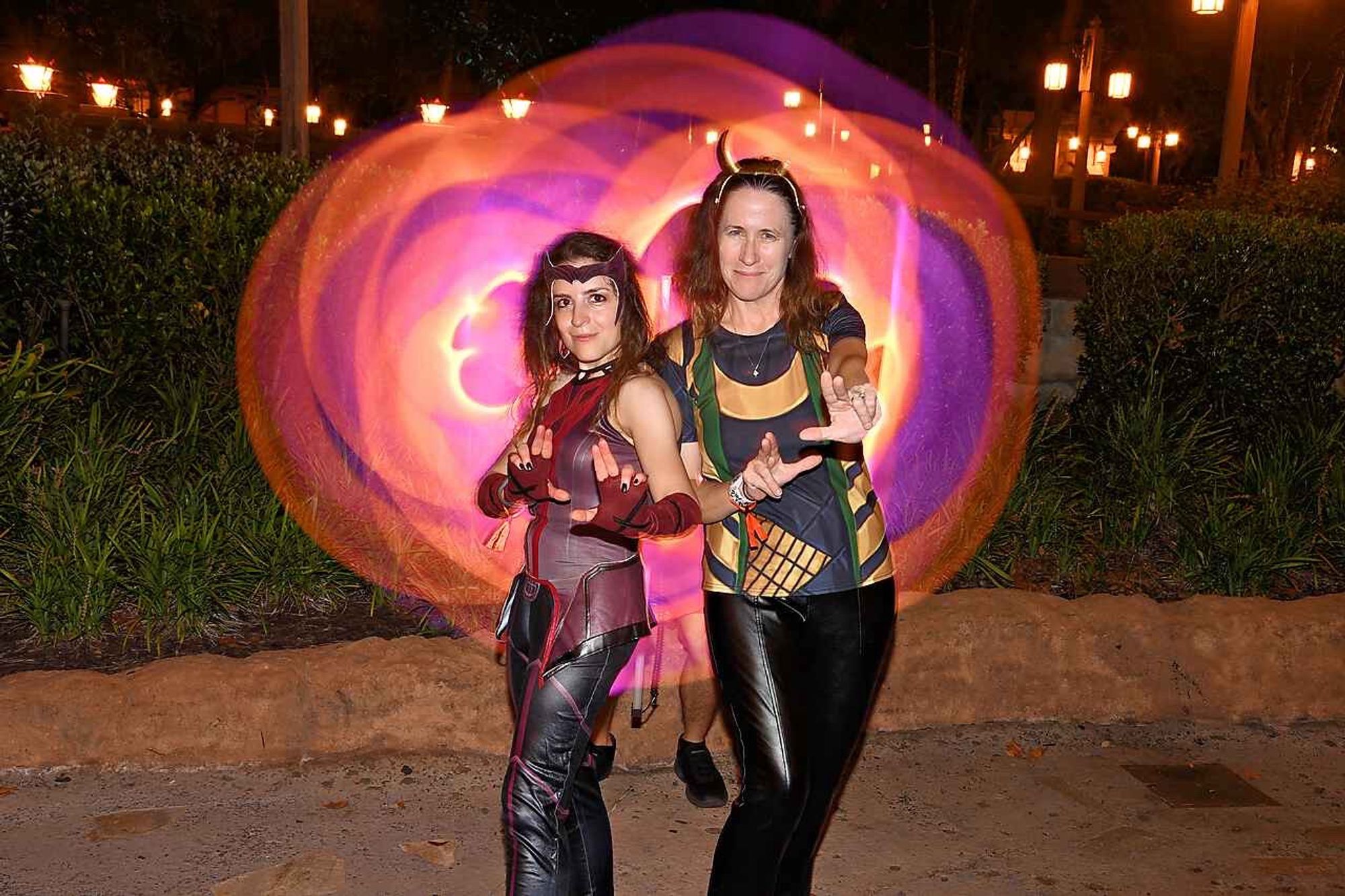 Me (on the right) and my friend dressed as Silvia (from Loki) while she’s dressed as the Scarlet Witch. We’re attempting to do a Doctor Strange kind of pose with circular colorful portal opening behind us