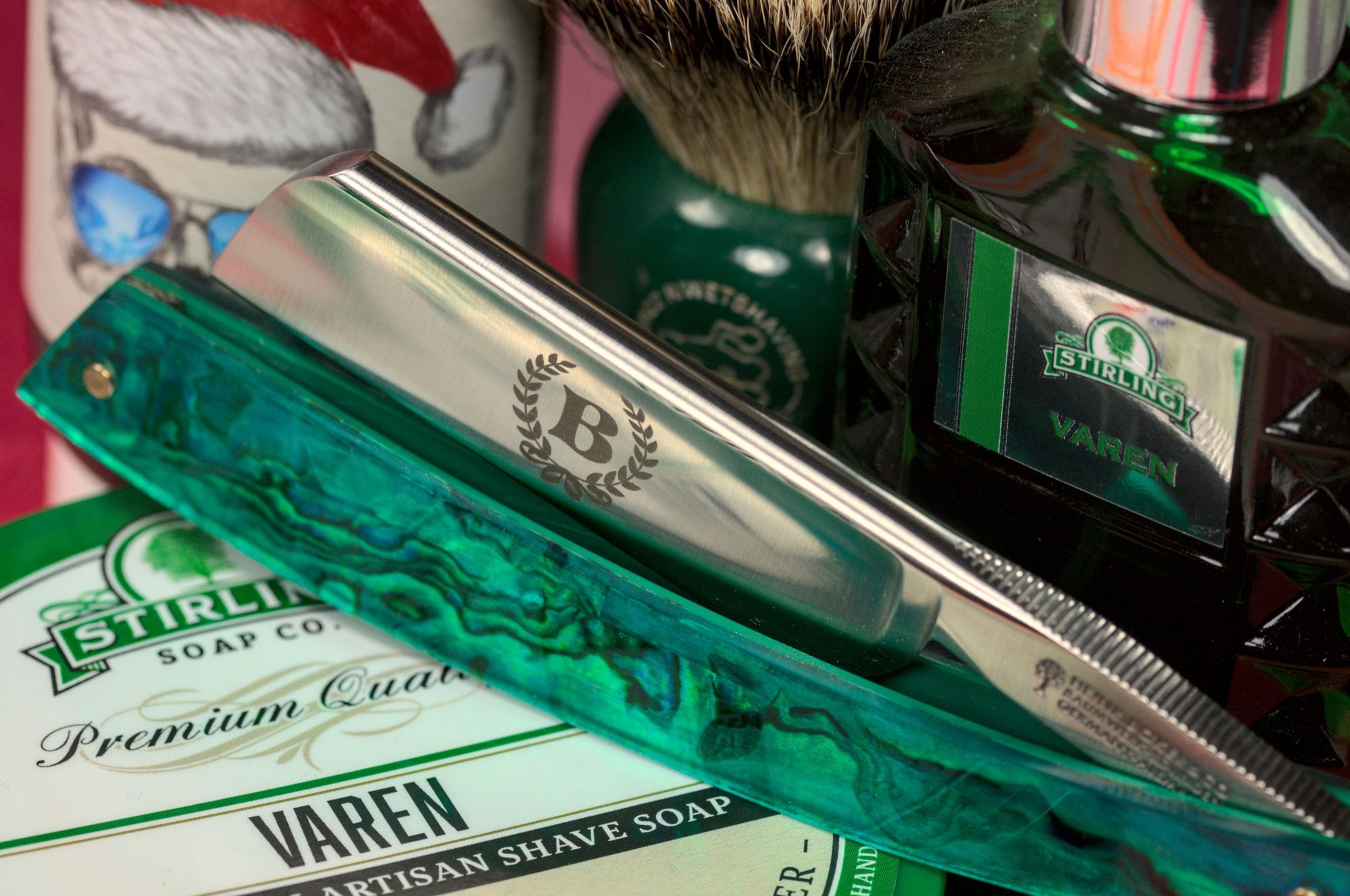 A closeup on a pretty Böker Abalone Straigt on a tub of Stirling Varen with a MOAR BADGER brush, a bottle of Beaudelaire splash and Varen frag
