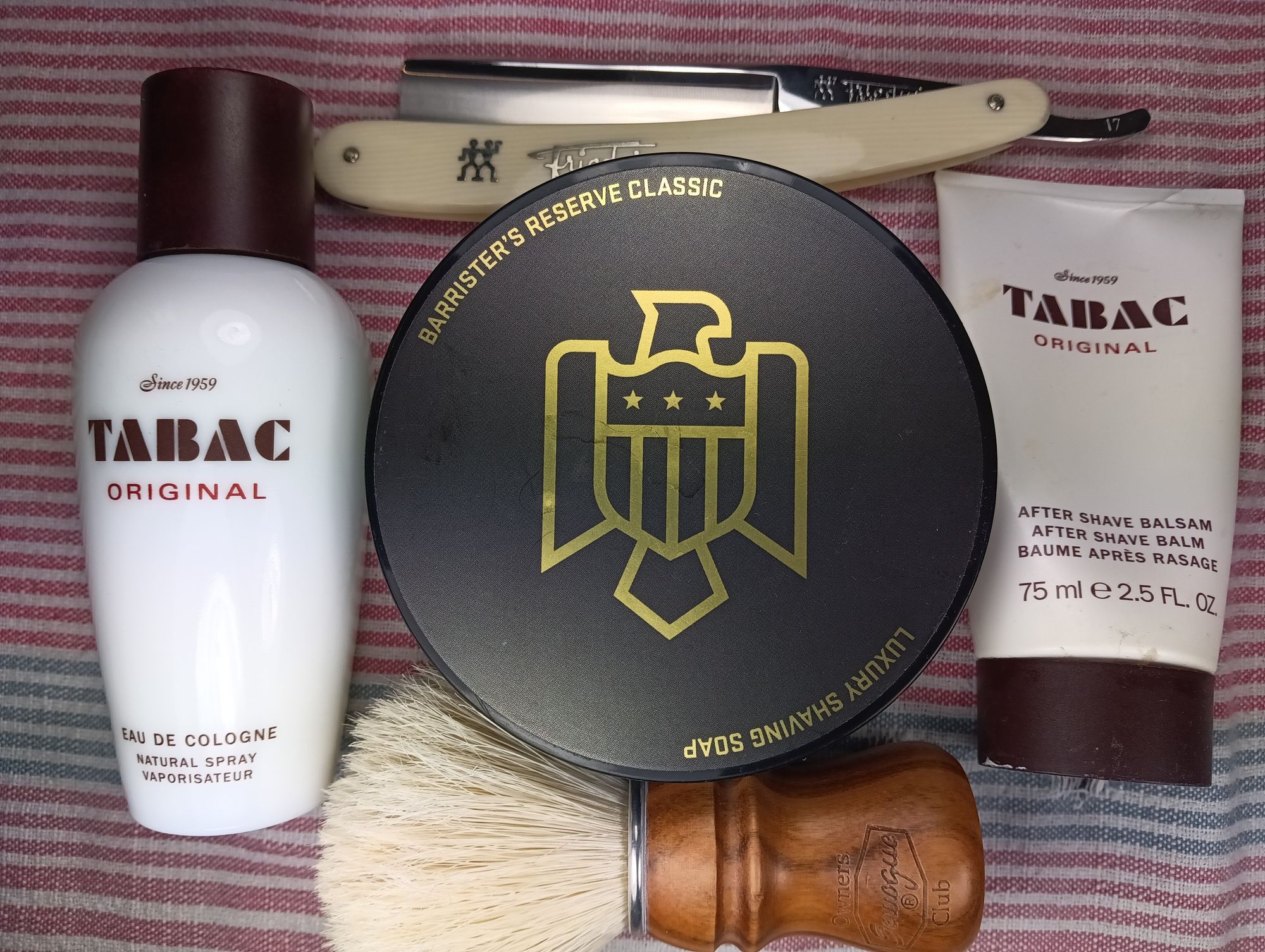 A tub of BaM Reserve Classic between a tube of Tabac Original balm, a bottle of Tabac Original frag, a SOC boar brush, and a chonky Frio 17