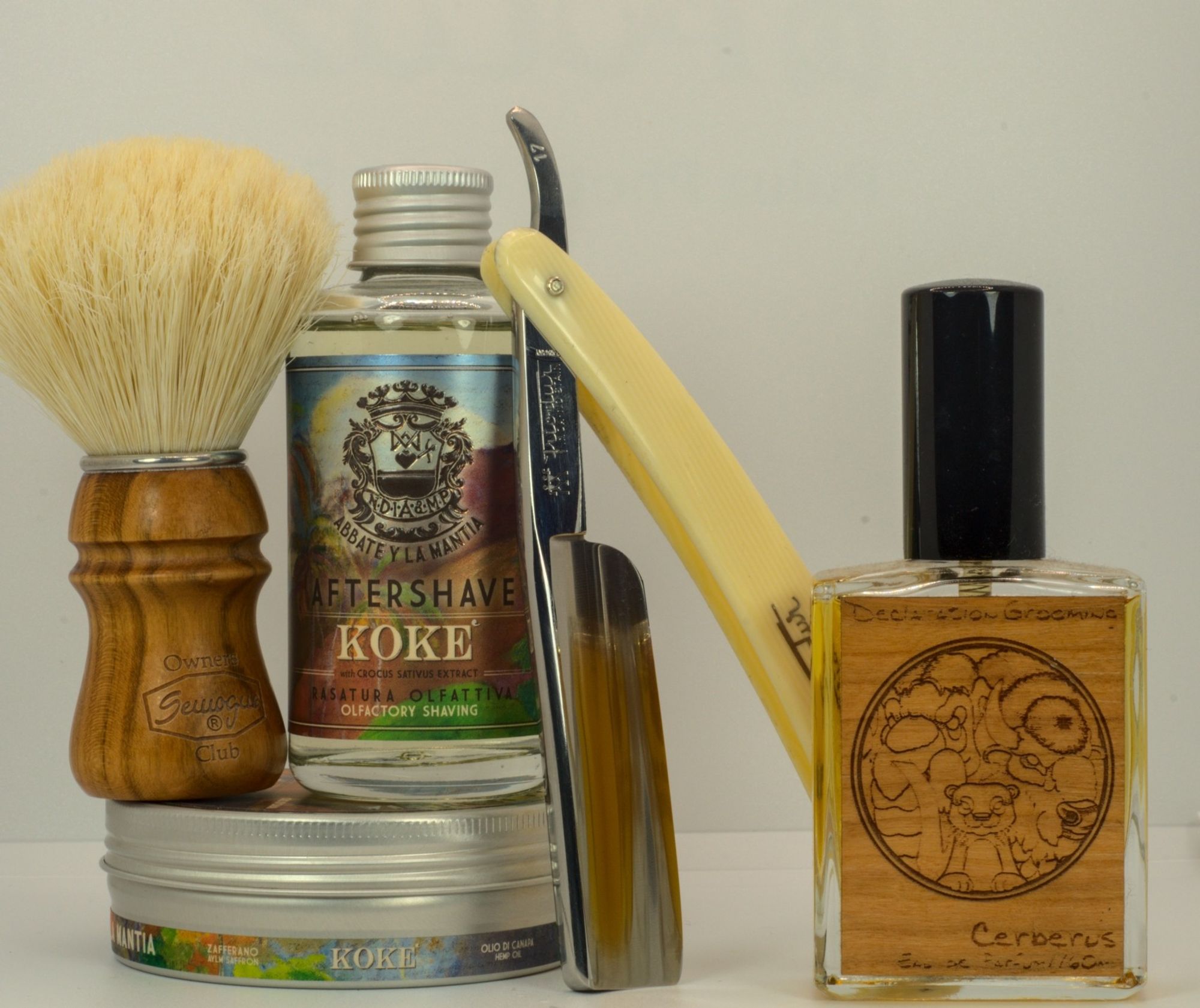 A set of AYLM Koké soap and splash with a chonky Frio 17, a SOC boar brush, and a bottle of NO/HoM/DG Cerberus frag