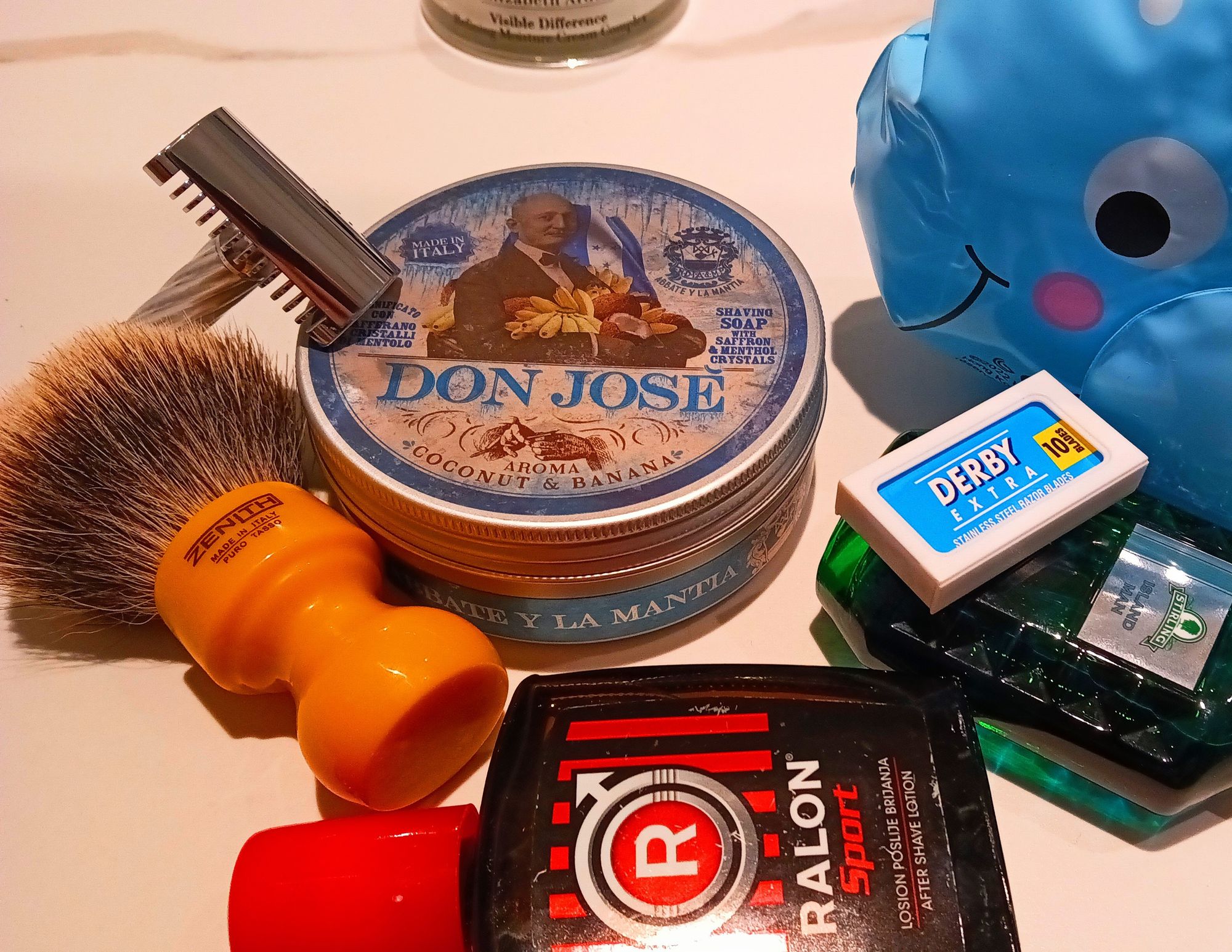 A tub of AylM Don Josè with bottles of Ralon Sport splash, Stirling Island Man frag, a Fatip Lo Storto razor and a pretty butterscotch Zenith badger