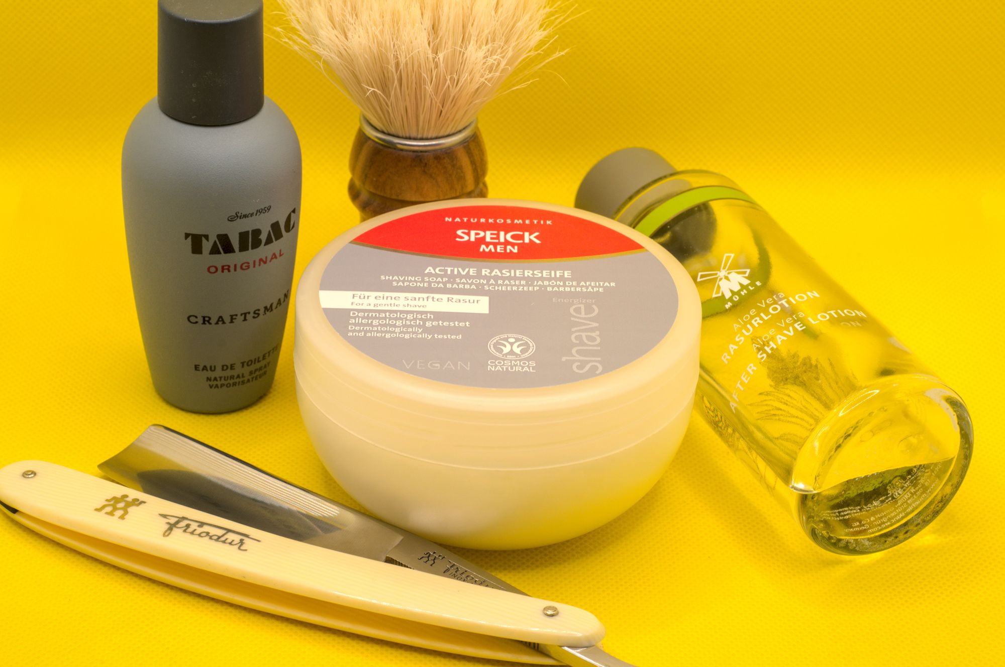 A tub of Speick Men soap surrounded by a chonky Friodur 17, a SOC boar brush, a bottle of Mühle splash, and Tabac Craftsman frag