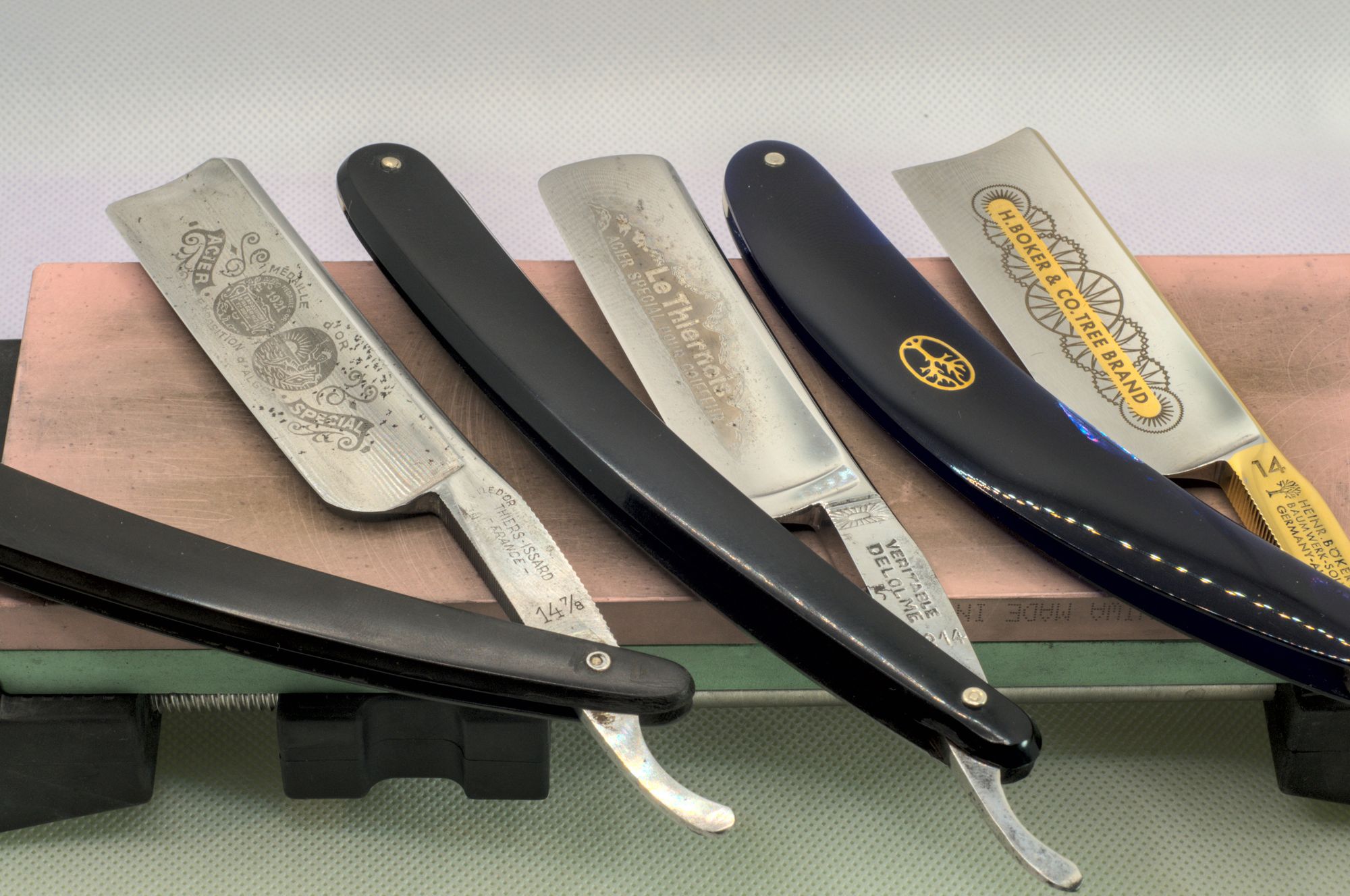 Three 14s no a sharpening stone. From left to right, a Thiers Issard Médaille d'Or 14, a Delolme Le Thiernois №14 "Spécial pour Coiffeur", and my pretty Böker 14er