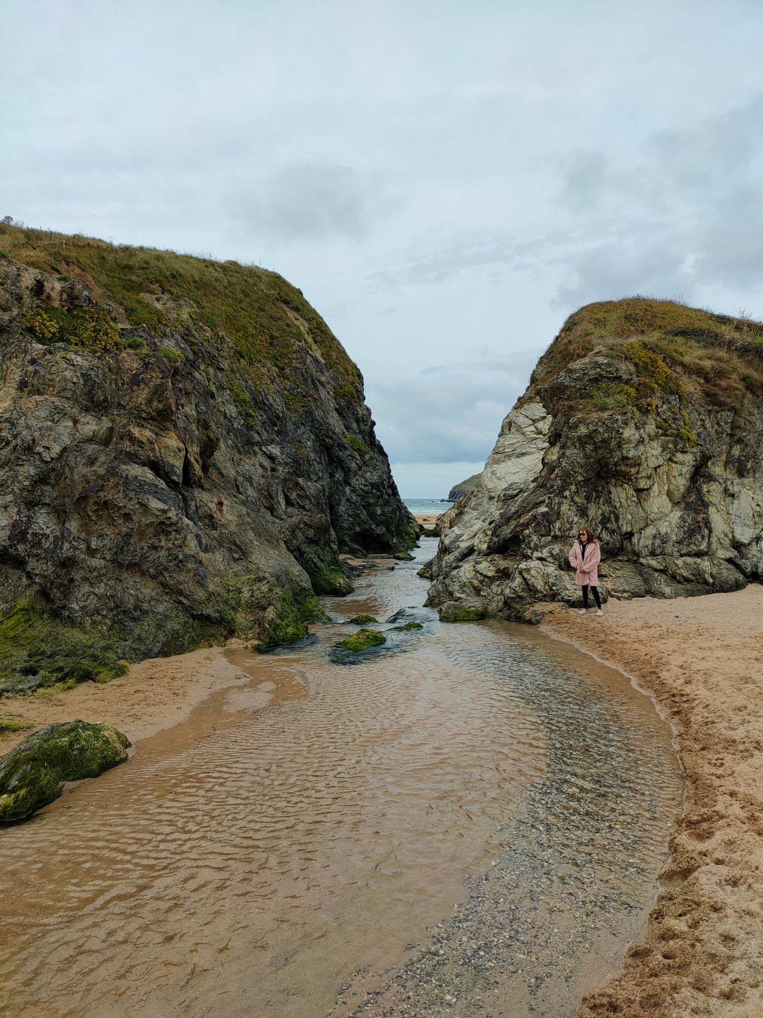 Stream that runs across the beach goes between two large granite hills before it reaches the sea.