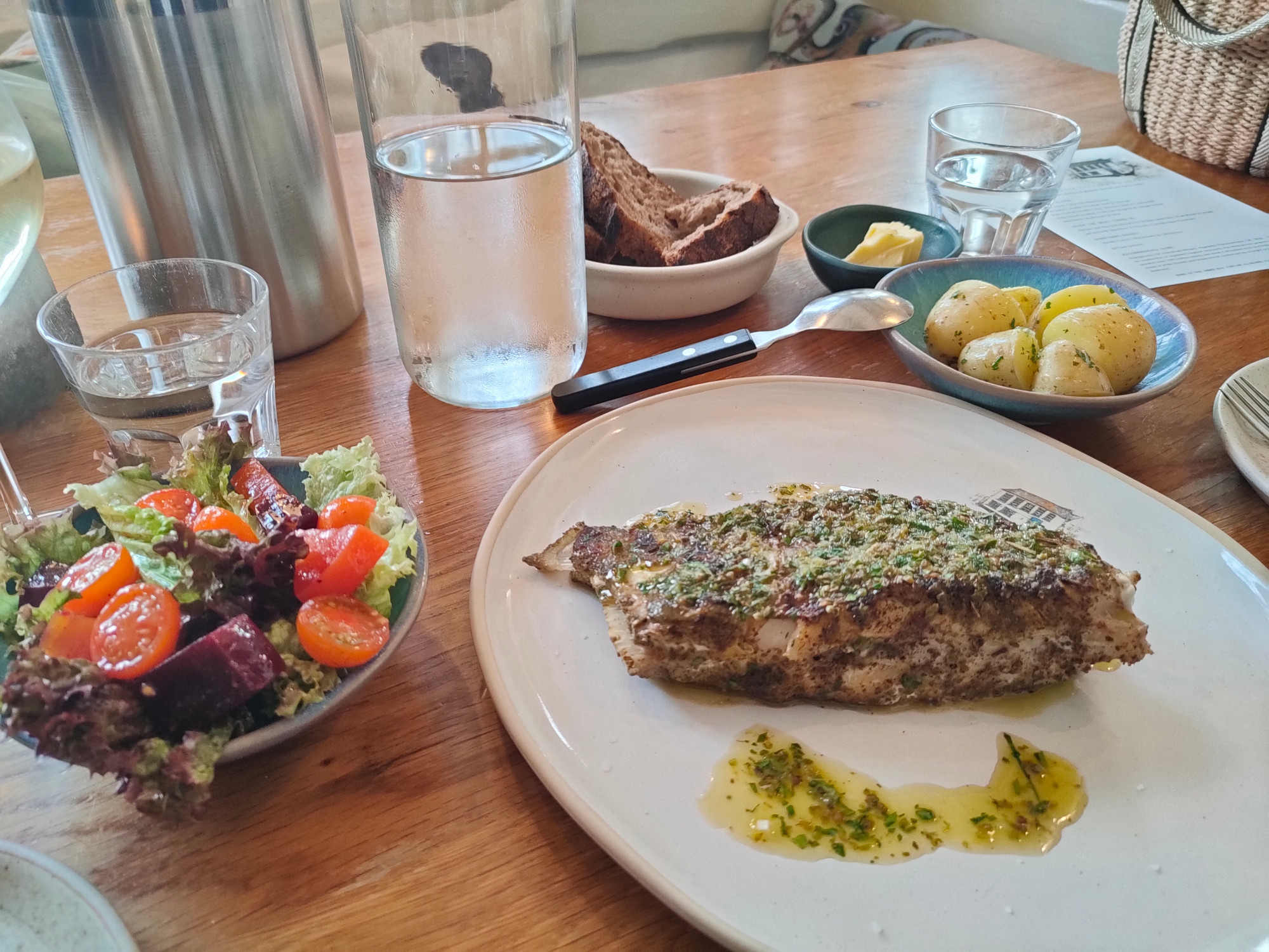 This is a terrible photo of an absolutely amazing dish. It was a whole John Dory but it looks more like a steak in this photo, although you can just about see the tail. Perfectly cooked. Served with Cornish new potatoes, plus a salad with honeycomb tomatoes and two different types of beetroot. One was standard beetroot, the other one looked like pieces of watermelon but actually tasted like beetroot.

The liquid at the bottom of the plate was the oregano, garlic and lemon dressing, which was also superb.