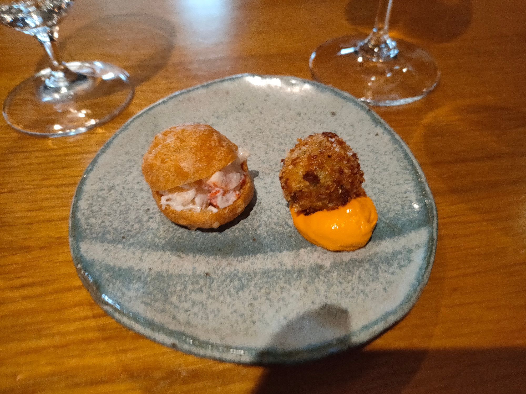 Tiny lobster roll as it's a 12 course menu. Lobster with parmesan and cayenne. Bonbon next to it is cuttlefish with spelt and paprika.