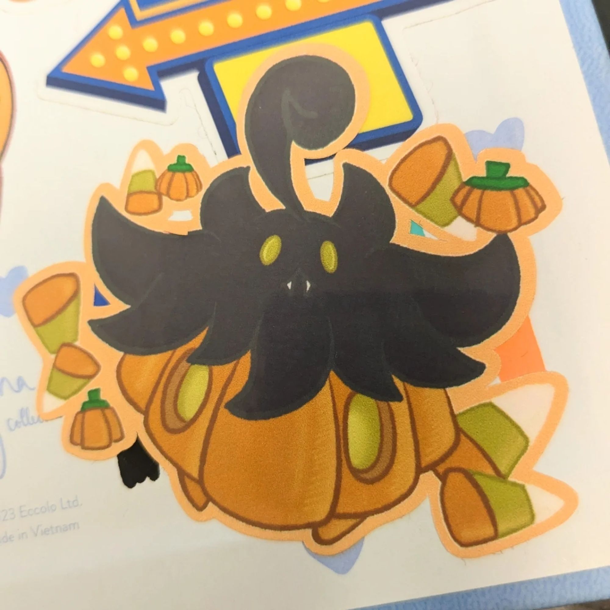 A sticker of a Pumpkaboo made out of a candy pumpkin with candy corn and pumpkins surrounding it