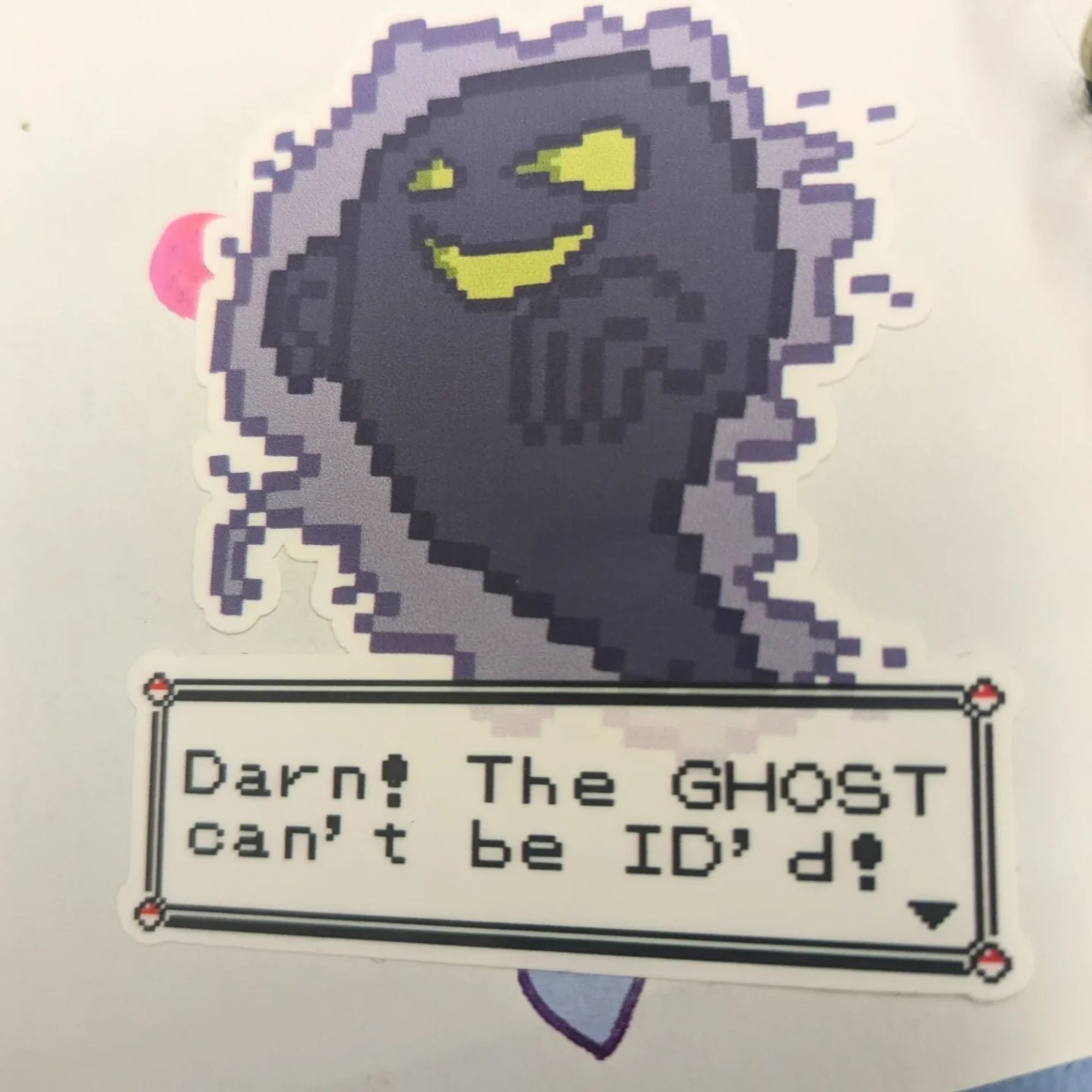 A sticker of the GHOST of Lavender Tower from Pokemon Red/Blue, reading "Darn! The GHOST can't be ID'd!"