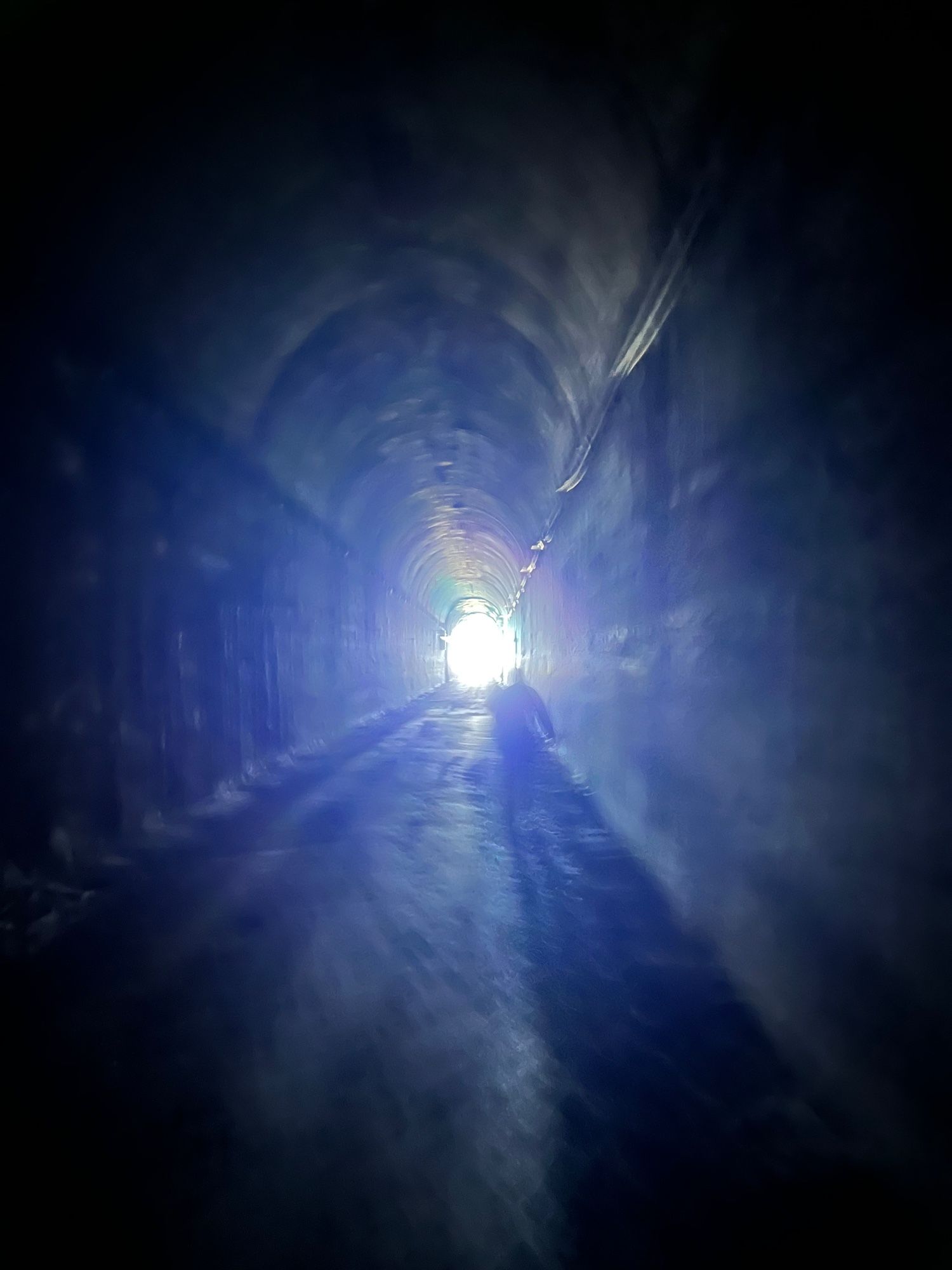 the same tunnel interior, but closer to the exit, and with a weird halo effect around the exit’s light 