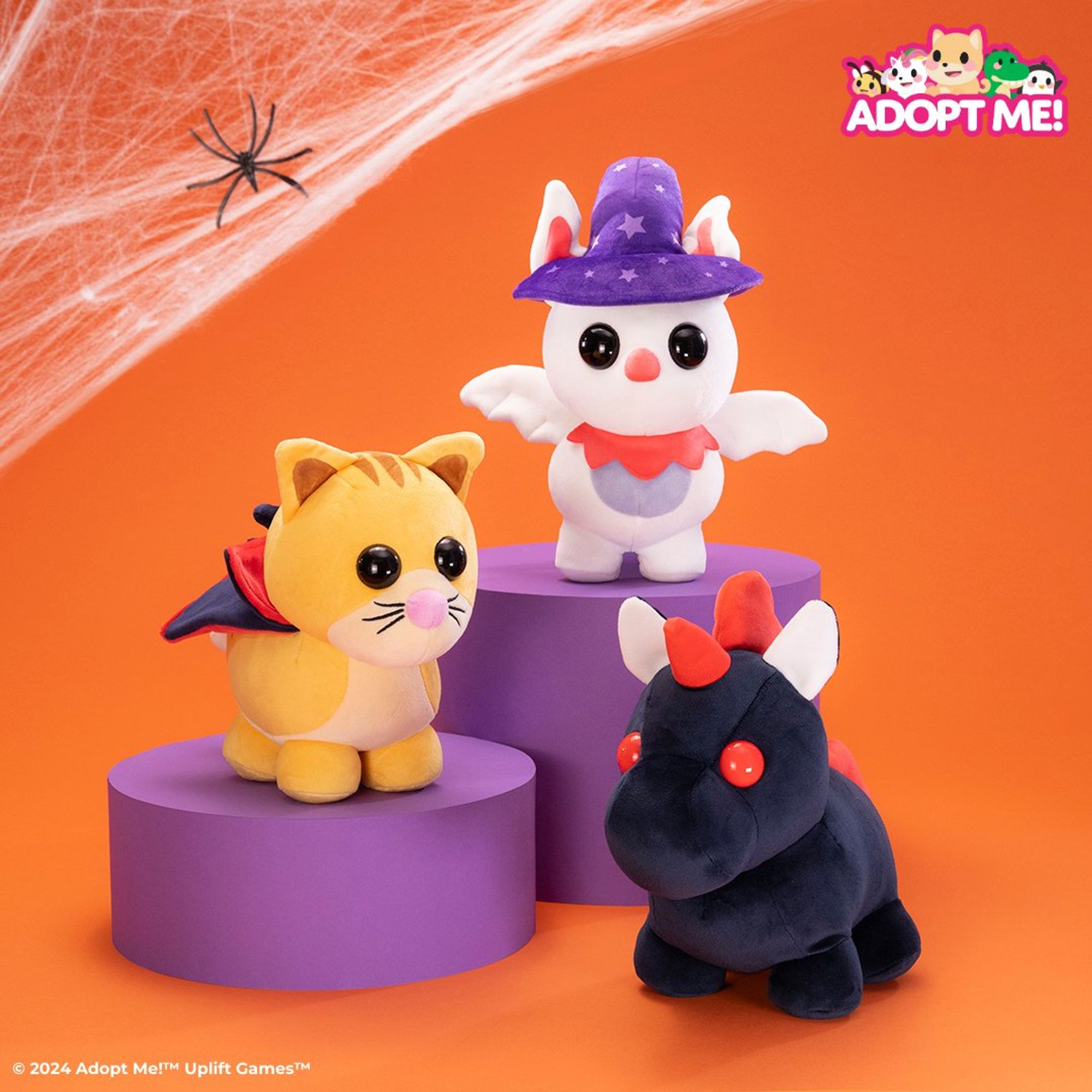 Image from @Jazwares on Twitter, showing Adopt Me's halloween plushies, one of which is an Evil Unicorn, one is a Ginger Cat with a cape, and one is an Albino Bat with a purple hat.