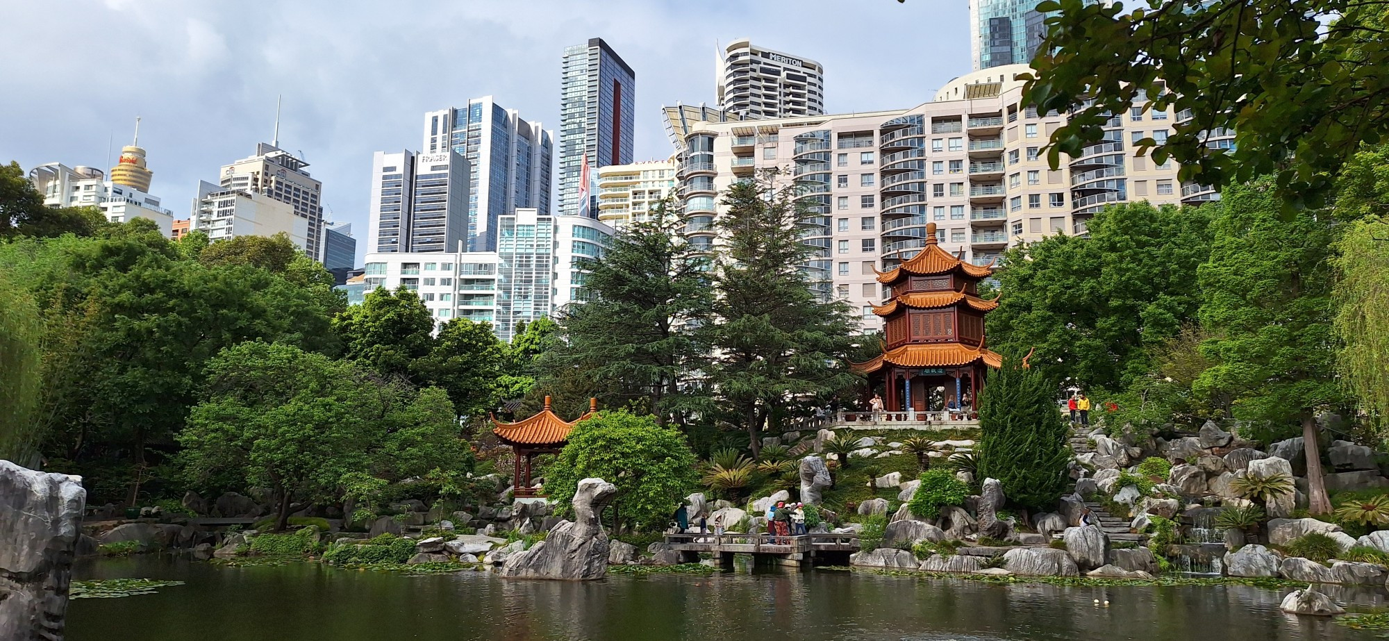 Chinese Garden if friedship, Chinatown, Sydney:
Chinese Pavilions above a pond with tall modern buildings in the background